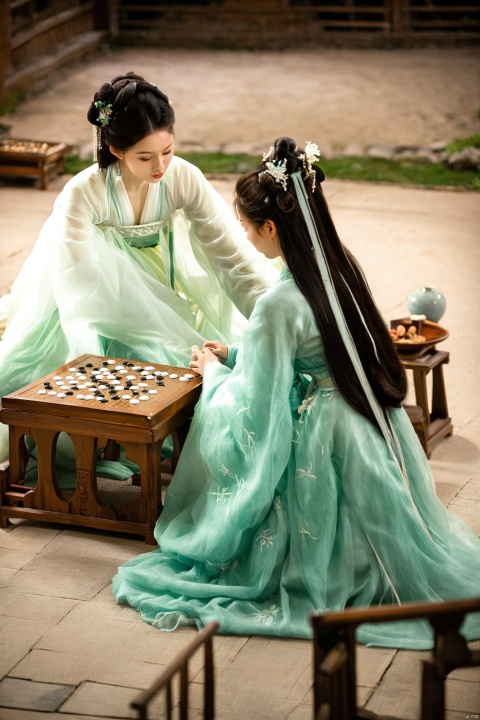 In a room adorned with traditional Chinese art, two women sit at a weiqi table, their focus solely on the game. The woman in white is a vision of concentration, her fingers moving with the grace of a dancer as she places a stone on the board. Her hanfu dress, with a high collar and a neckline that hints at her cleavage, is a canvas for the delicate embroidery that adorns it. The fabric of her dress flows like a stream around her, a visual representation of the fluid game of weiqi.
Her opponent, in a green that complements the room's decor, is equally engrossed in the game. Her hanfu, with its high collar and fitted silhouette, accentuates her form, while the dress's neckline reveals a tantalizing view of her décolletage. As they play, their eyes meet over the board, and there's a spark of friendly competition, their shared love for the game evident in their expressions.