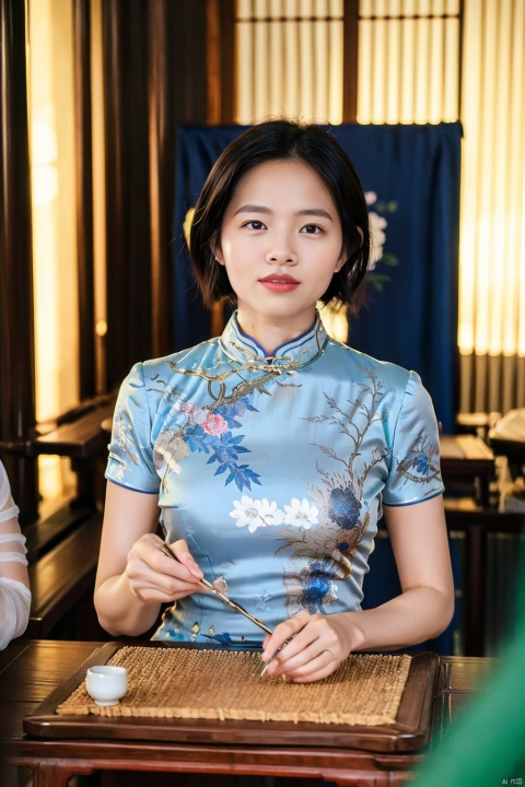 chinese clothes, black hair, table, smile, holding, dress, looking at viewer, 1girl, blurry, grin, solo focus, black eyes, short sleeves, indoors, blue dress, female focus, china dress, blurry foreground, short hair, cheongsam, realistic, south beauty
