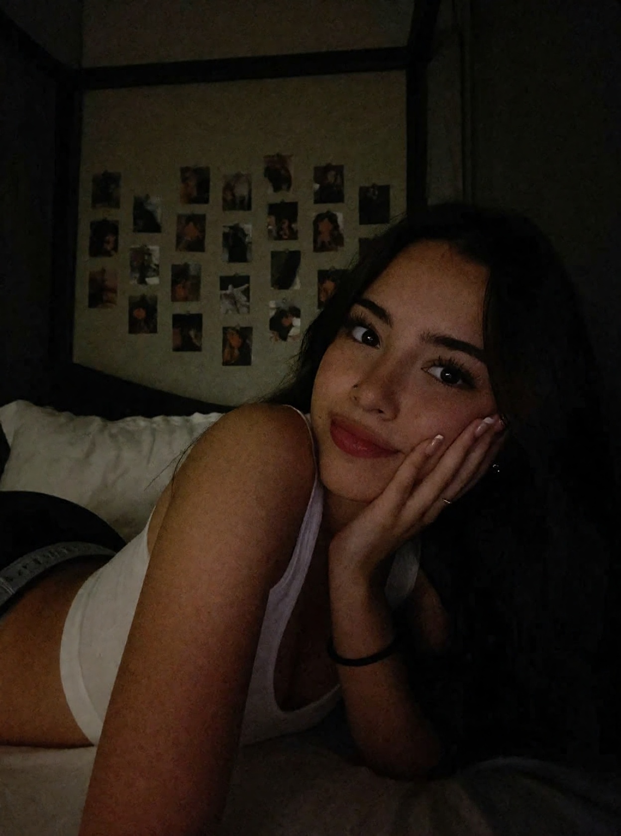 r3alism,  A woman with long,  dark hair rests their cheek against their hand on Tensor.Art