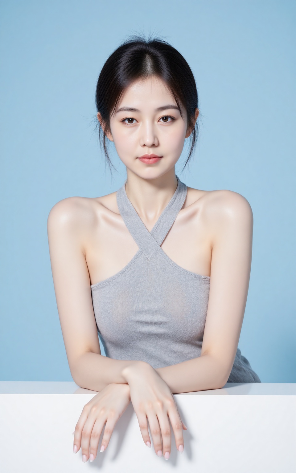 RUNYAN,RUNYAN Wearing a light gray sleeveless halter top. She leans forward and rests her arms on a white surface against a light blue background. Soft makeup accentuates her delicate features.,