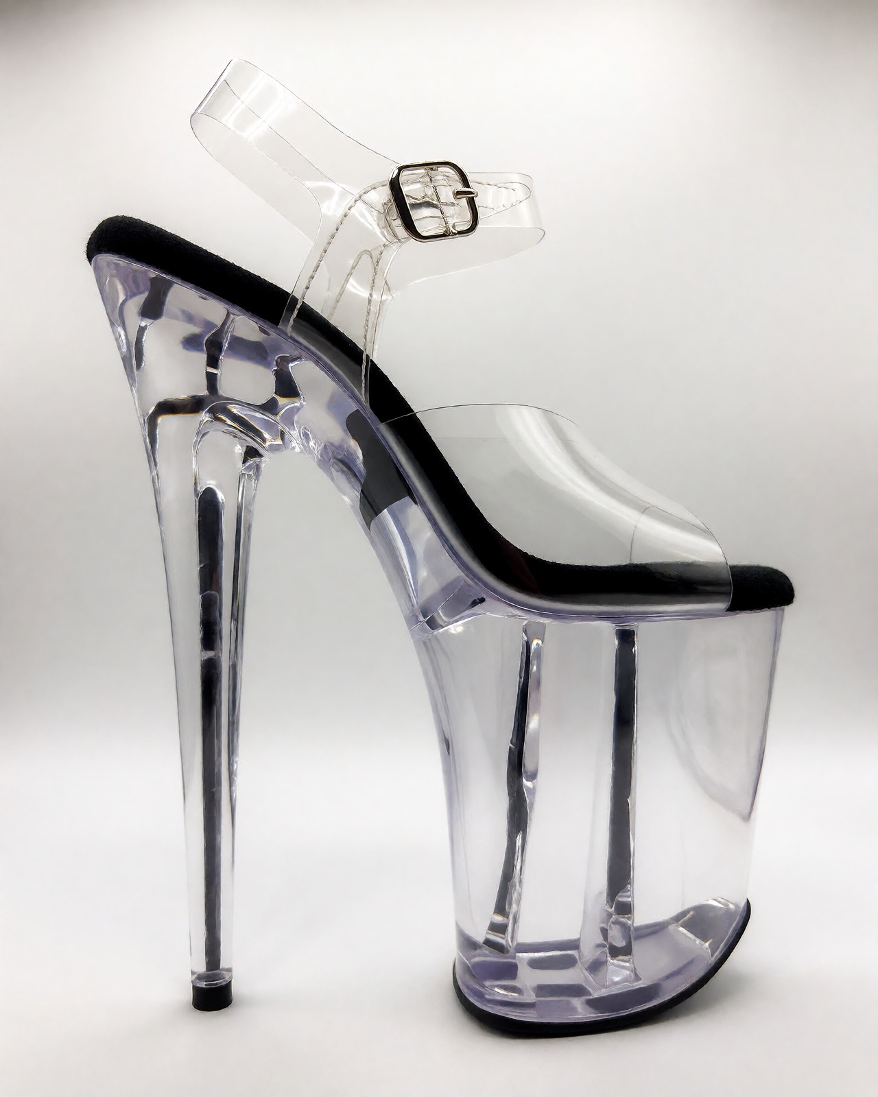 A clean product photograph of fully transparent clear acrylic Pleasers Flamingo extreme platform heels standing upright on...
