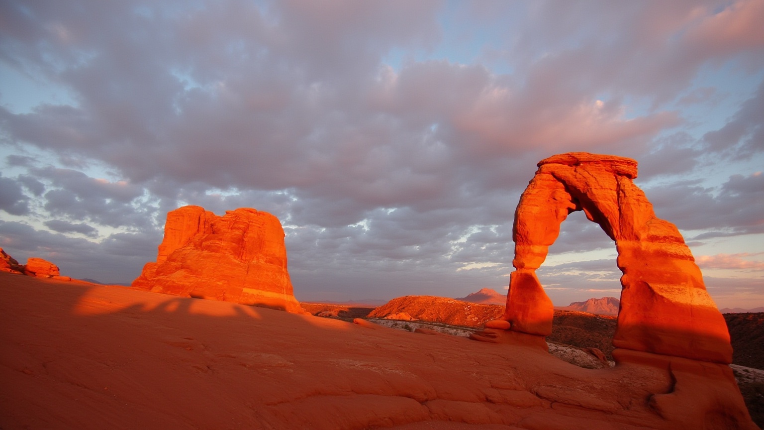 This is a high-resolution photograph capturing the iconic natural arch formation known as the Delicate Arch in Arches Nati...