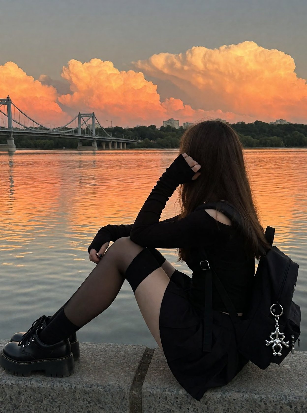 r3ealism,  A person with long brown hair sits in profile on a stone ledge,  overlooking a wide river during a vivid sunset...