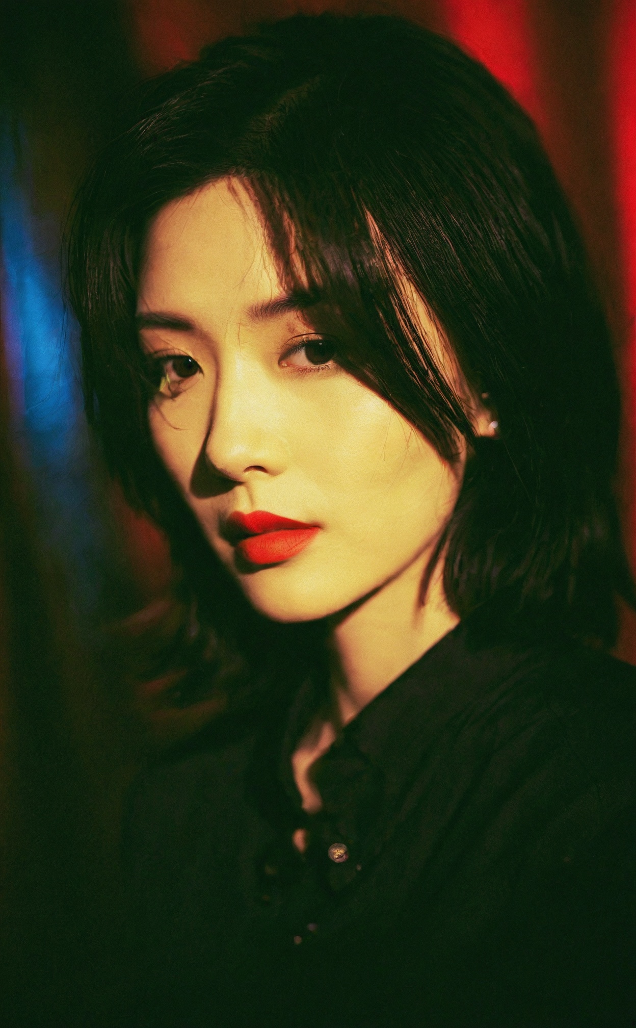 mugglelight, there is an asian woman with a red lipstick and a black shirt, solo, male focus, portrait, black hair, black eyes, close-up