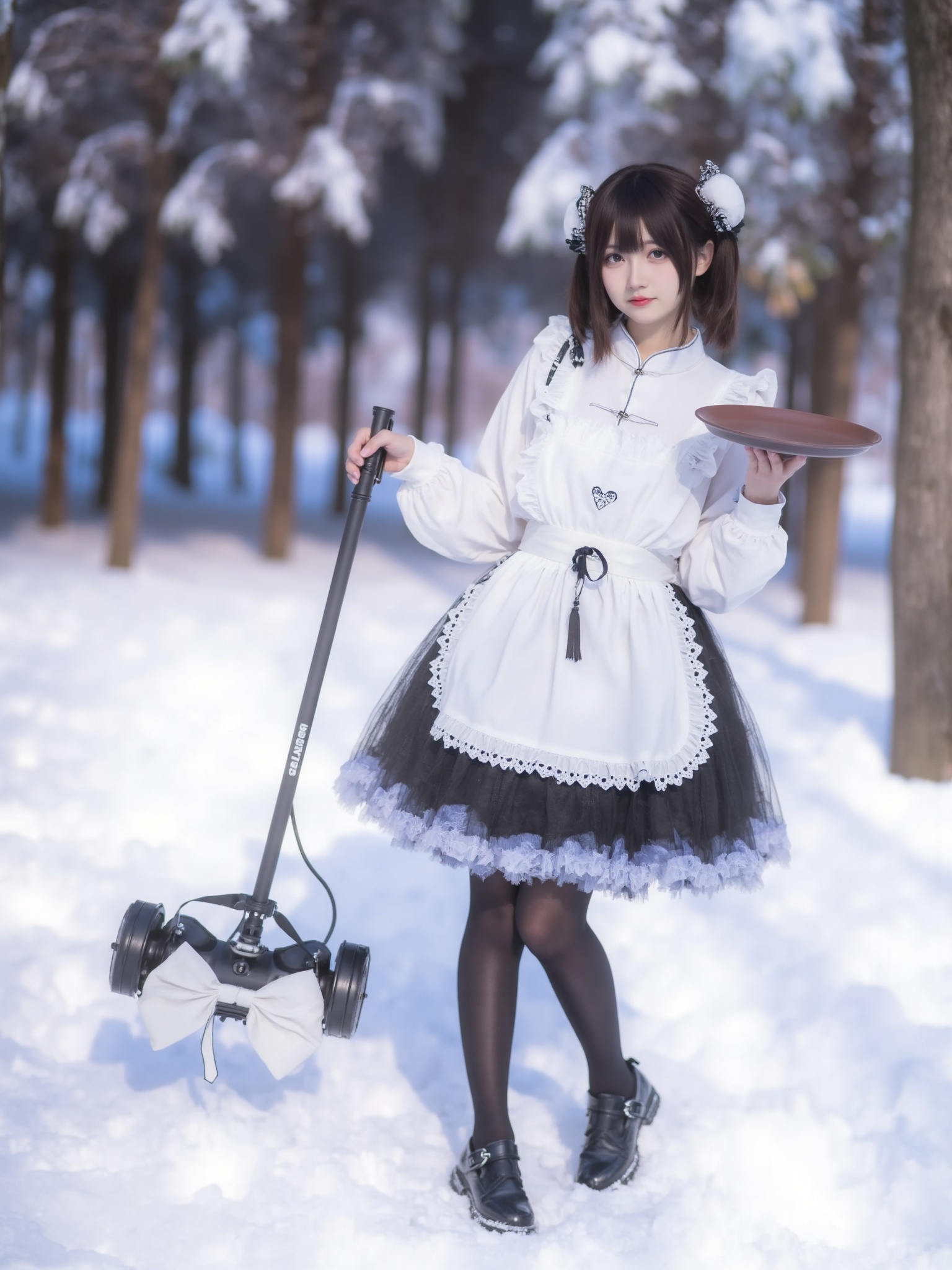 This is a photograph of a young woman standing in a snowy forest. She has a fair complexion and dark brown hair styled in pigtails adorned with white bows. She is dressed in a traditional Japanese maid cosplay outfit featuring a white blouse with ruffled trim and a black,frilly skirt with a white apron. Her outfit is accented with black knee-high socks and black Mary Jane shoes. She holds a tray with a brown plate in her right hand,while her left hand is holding a black,robotic vacuum cleaner with a white bow attached to its handle. The background shows a forest covered in snow,with tall trees and a bluish-white sky. The ground is blanketed in snow,and the overall atmosphere is cold and serene. The photograph is taken in a bright,clear day,with the sun casting soft shadows on the snowy ground. The image is crisp and detailed,with a high-resolution quality that captures the textures of the snow and the fabric of her costume.,<lora:YY-超女-女仆装F.1:1>,