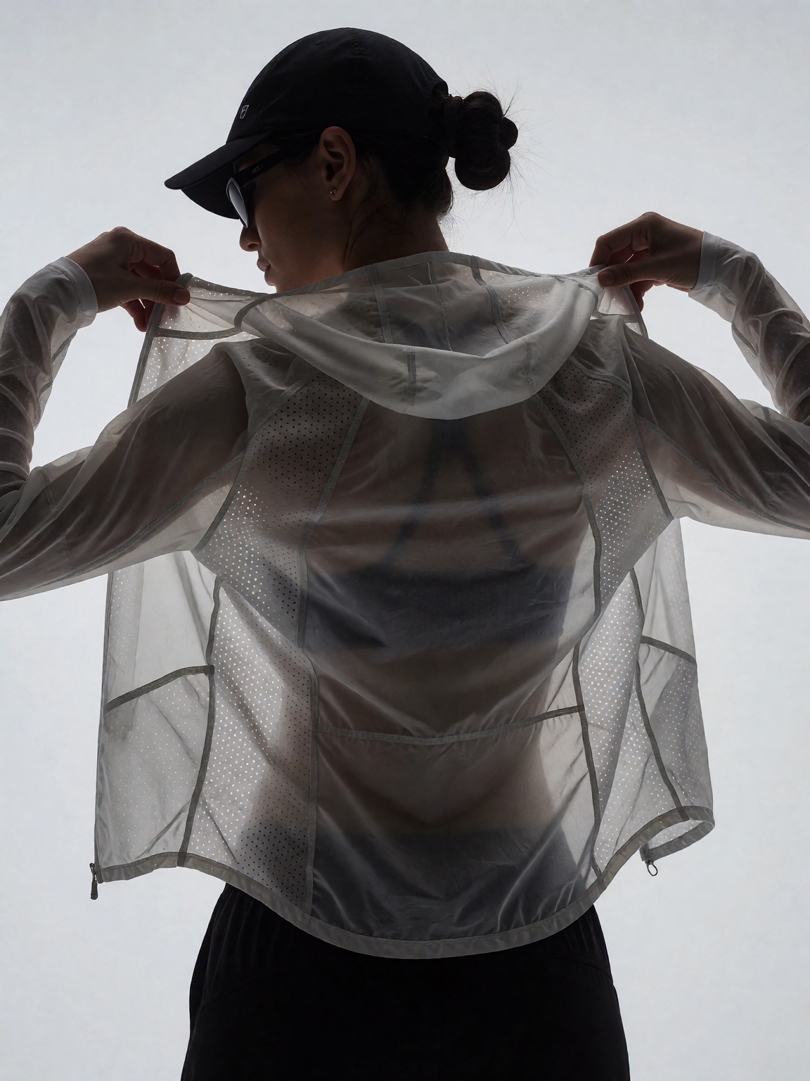 A person,  seen from behind in silhouette against bright light,  adjusts a translucent on Tensor.Art