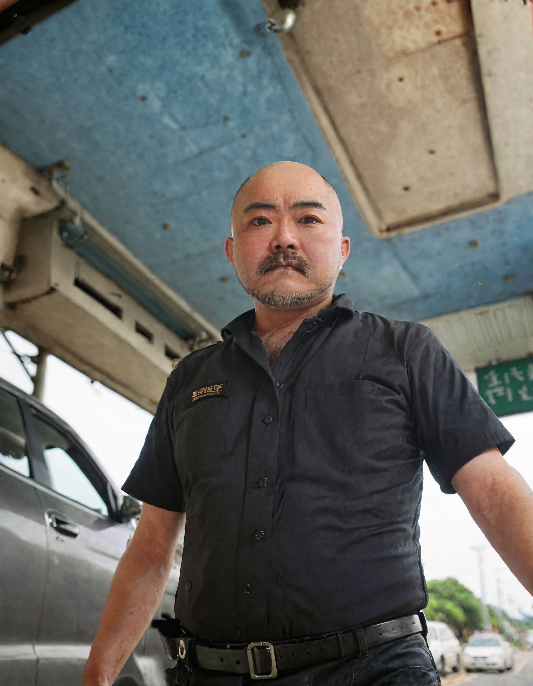 JPyoruno, solo, looking at viewer, shirt, 1boy, short sleeves, male focus, blurry, uniform, black shirt, facial hair, from below, ground vehicle, motor vehicle, beard, realistic, car, bald  <lora:SDXL.东亚矮矬男JPyoruno:0.88>
