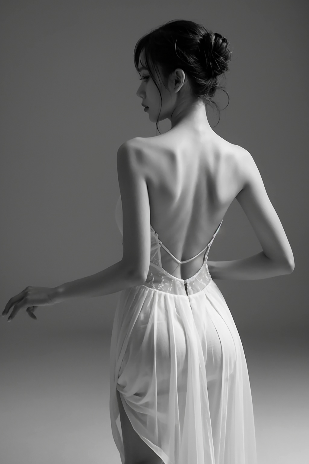 solo,1girl,monochrome,greyscale,is dancing,ballet,dance,updo,bare shoulders,backless outfit,dress,skirt,wind,braid,single hair bun,backless dress,<lora:heibai_20231113120702:0.5>,