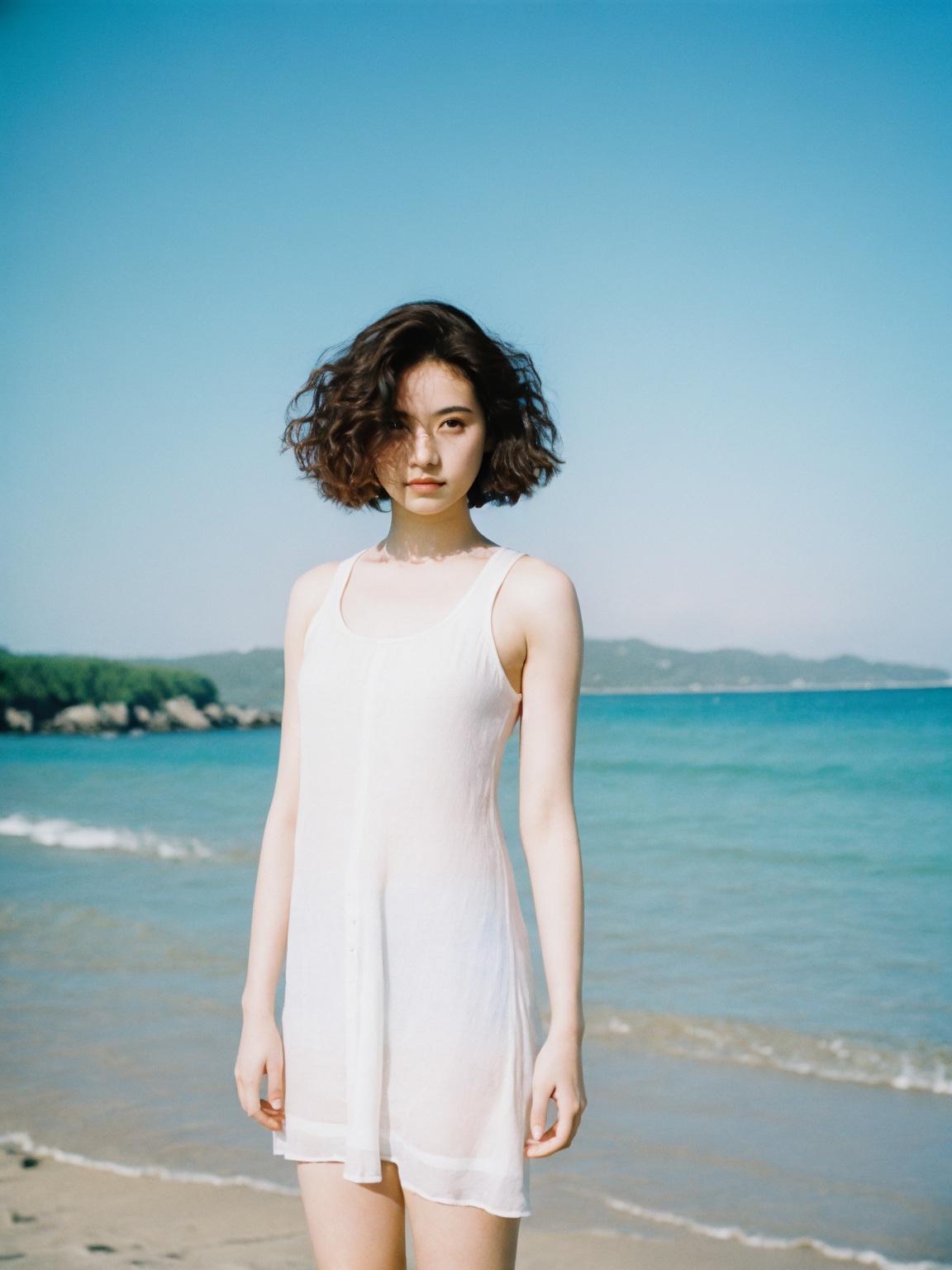 film grain analog photography,1girl, woman white dress standing beach, pure blue sky, portrait japanese girl, short hairstyle, energy flowing, **** top fashion, curly-haired, dehazed image, breathe, mid,
