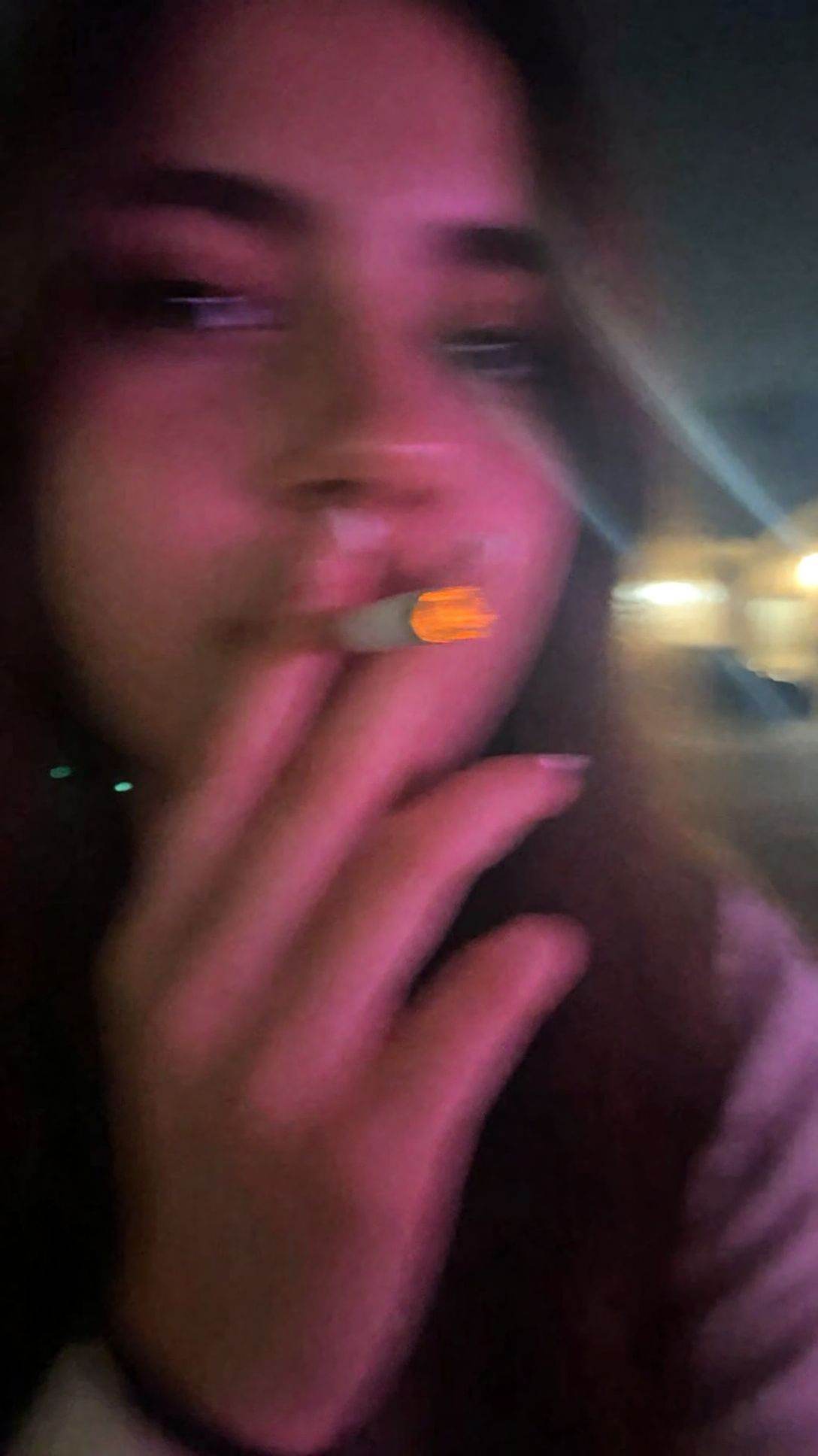 r3ealism,  An out-of-focus,  low-resolution close-up captures a person partially obscuring their face with their hand whil...