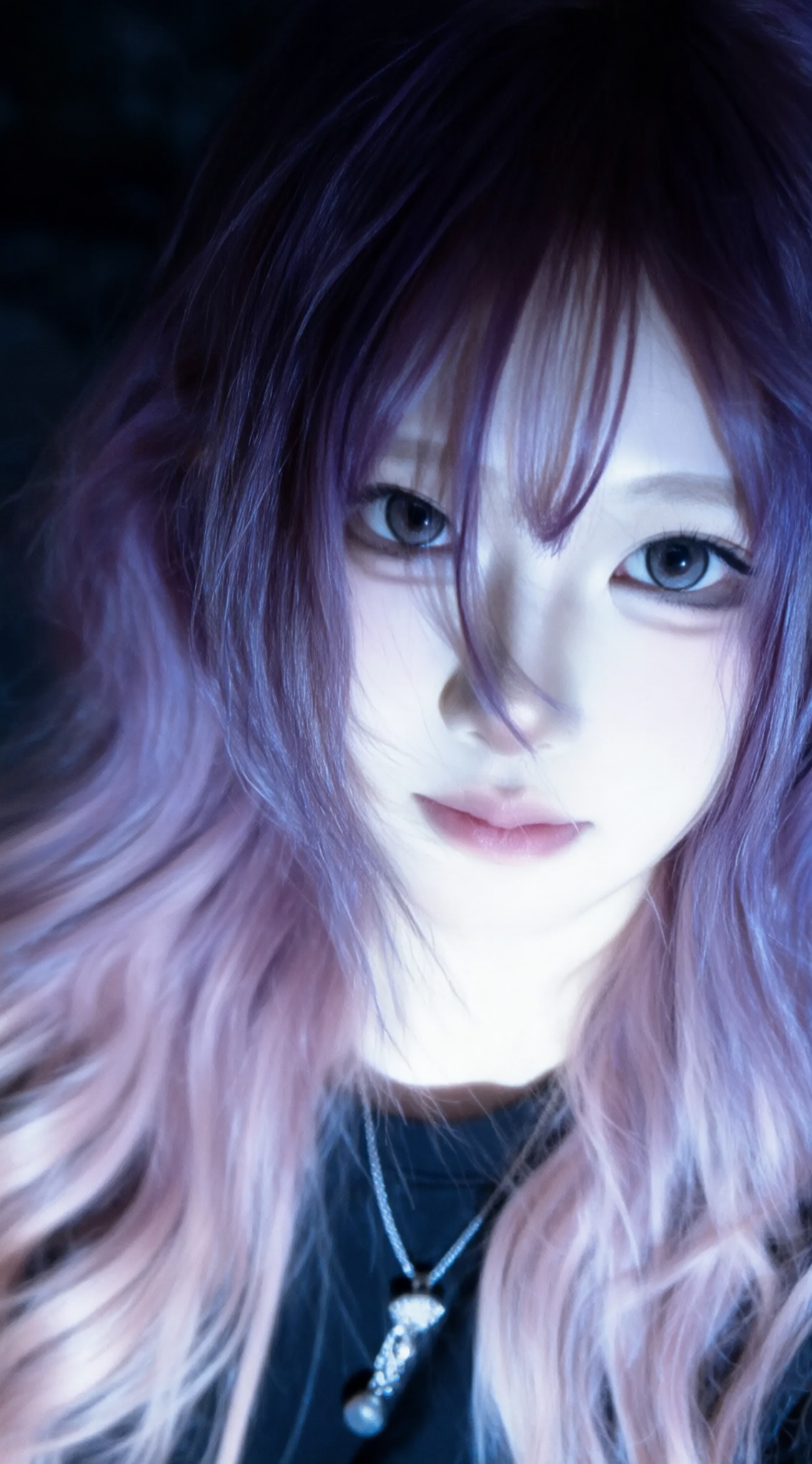 a close-up portrait of a young woman with long, wavy hair featuring shades of purple and pink, she has a serious expression and is looking directly at the viewer, her eyes are large and expressive, with a hint of a smile, she is wearing a black top and a silver necklace with a pendant, the background is dark and blurry, with soft lighting that highlights her features, the image has a dreamy, ethereal quality with a focus on the womans face and hair,, Negative prompt: ng_deepnegative_v1_75t,(badhandv4:1.2),EasyNegative,(worst quality:2),,nsfw, Steps: 30, Sampler: Euler, CFG scale: 4.0, Seed: 3103506506, Size: 1142x2048, Model hash: 98763a1277, Model: Qwen-Image_1.0.safetensors, Denoising strength: 0, RNG: CPU, Lora 1: ZOZ_湿润特效, Lora Hash 1: 36836624eb, Lora Weight 1: 0.8, vae_name: automatic