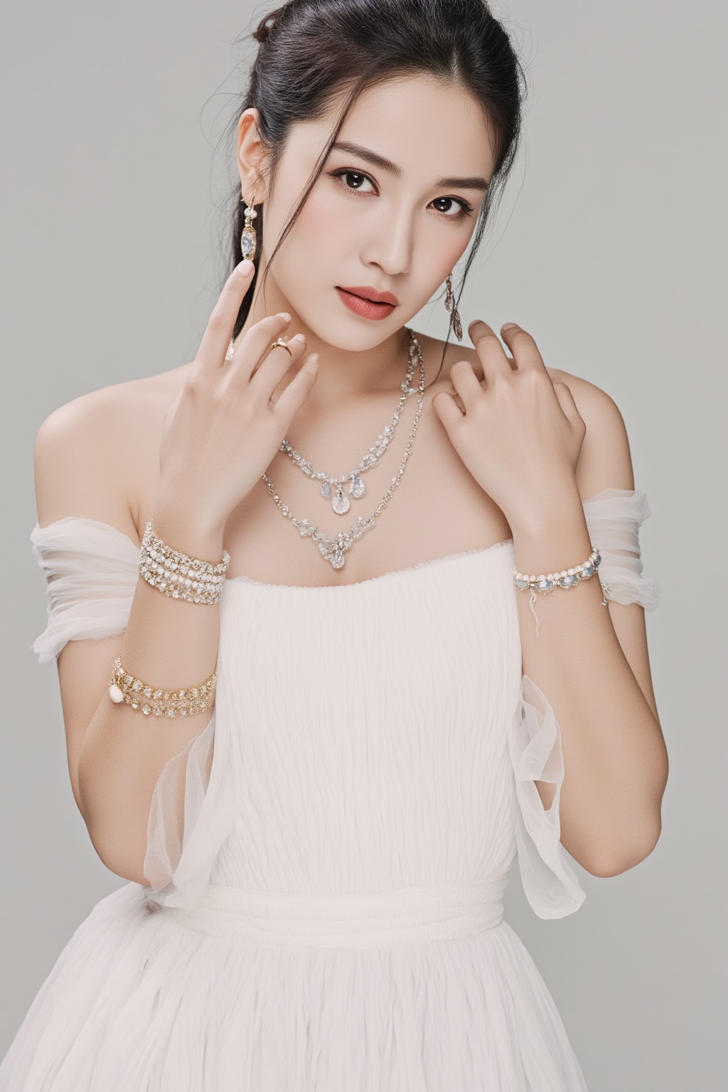 A woman is wearing a white dress. She has a necklace around her neck. There are bracelets on her wrist and a ring on her finger. The woman has earrings on her ears.