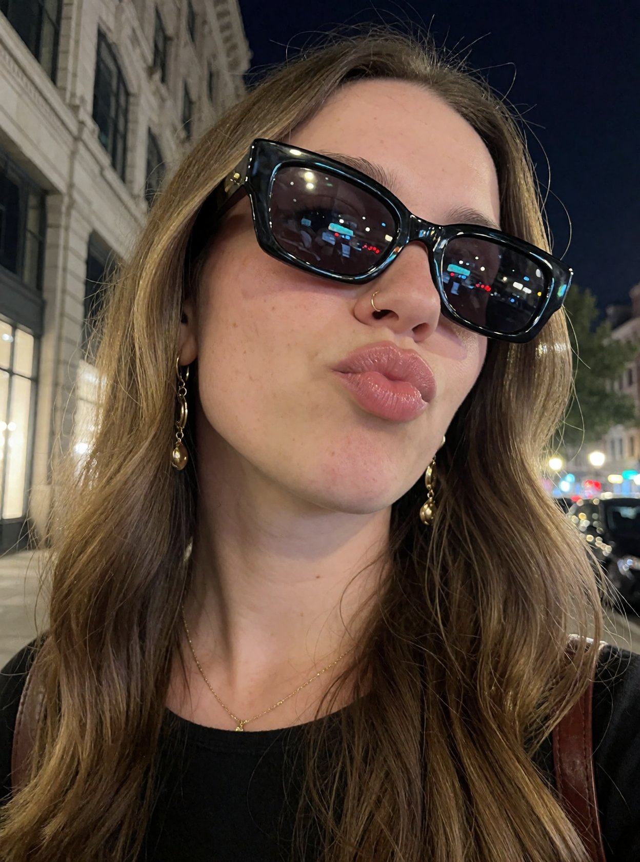 r3ealism,  A woman with long,  light-brown hair poses for a close-up selfie in an urban setting at night on Tensor.Art