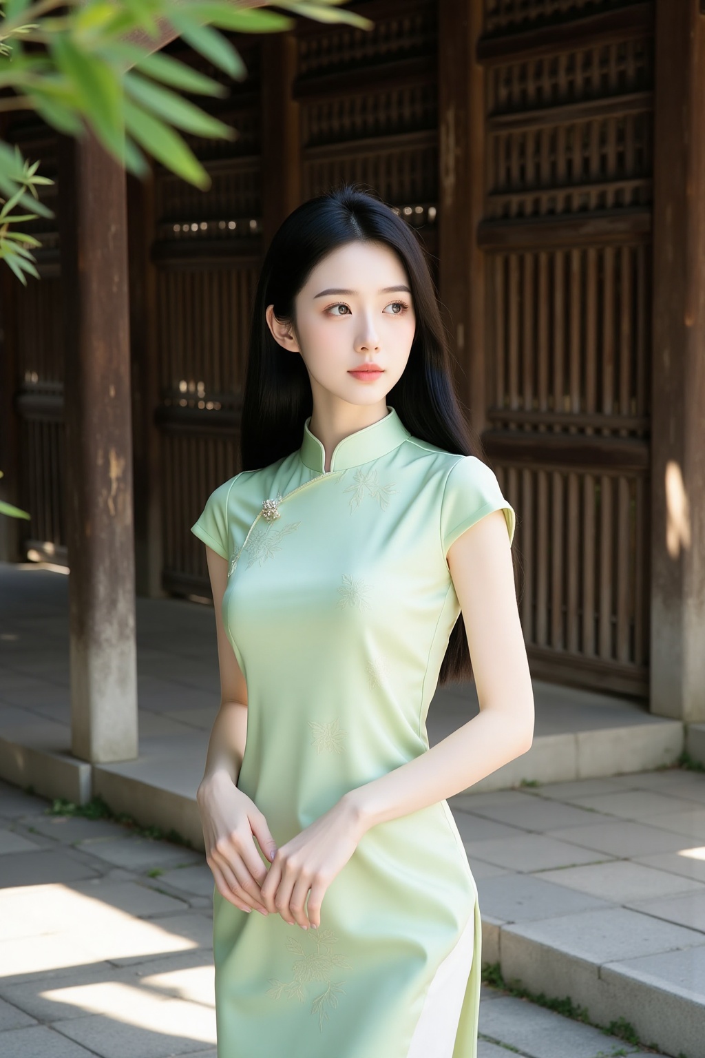 cheongsam,This is a high-resolution photograph featuring a young Asian woman standing outdoors in a serene,sunlit setting. She has a fair complexion and long,straight black hair that falls past her shoulders. Her expression is calm and slightly contemplative,with her lips slightly parted and her gaze directed slightly to her left. She is wearing a traditional Chinese cheongsam dress in a soft,pale green color with a subtle marble-**** pattern. The dress has a high collar,short sleeves,and a small keyhole opening at the neckline. The fabric appears to be smooth and slightly shiny,reflecting light and adding a touch of elegance to her appearance.,The background features a wooden structure with vertical slats,likely part of a traditional building or pavilion. The ground is paved with gray stones,and there is a hint of greenery with bamboo leaves visible on the left side of the image. The lighting is natural,casting soft shadows and highlighting the textures of both the woman's dress and the wooden structure. The overall mood of the photograph is tranquil and elegant,capturing a moment of peaceful contemplation in a beautiful outdoor setting.,