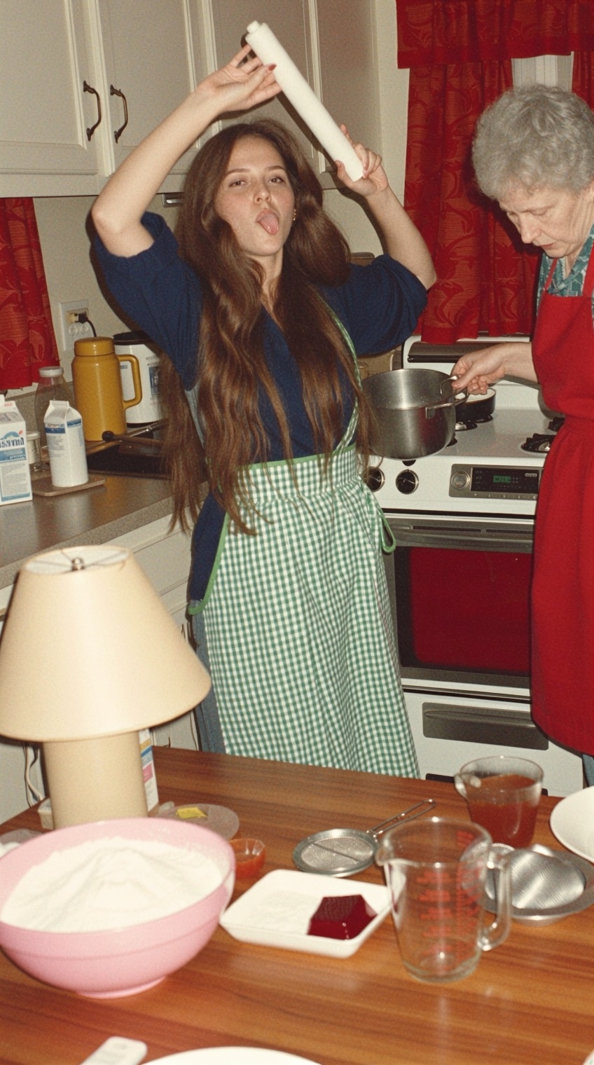 a young woman with long,  wavy brown hair stands in a vintage kitchen,  playfully sticking out her tongue while holding a...