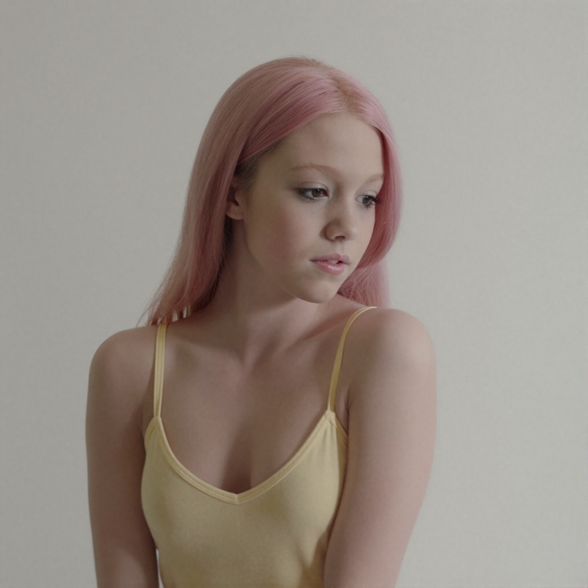 The image depicts a young **** with an unnervingly slender build and an elongated head-to-body ratio that accentuates her...