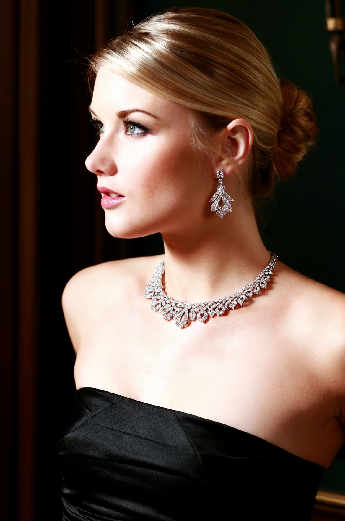 SUBJECT: wpJ33l,  blonde woman with flawless complexion and graceful features CLOTHING: black strapless evening attire vis...