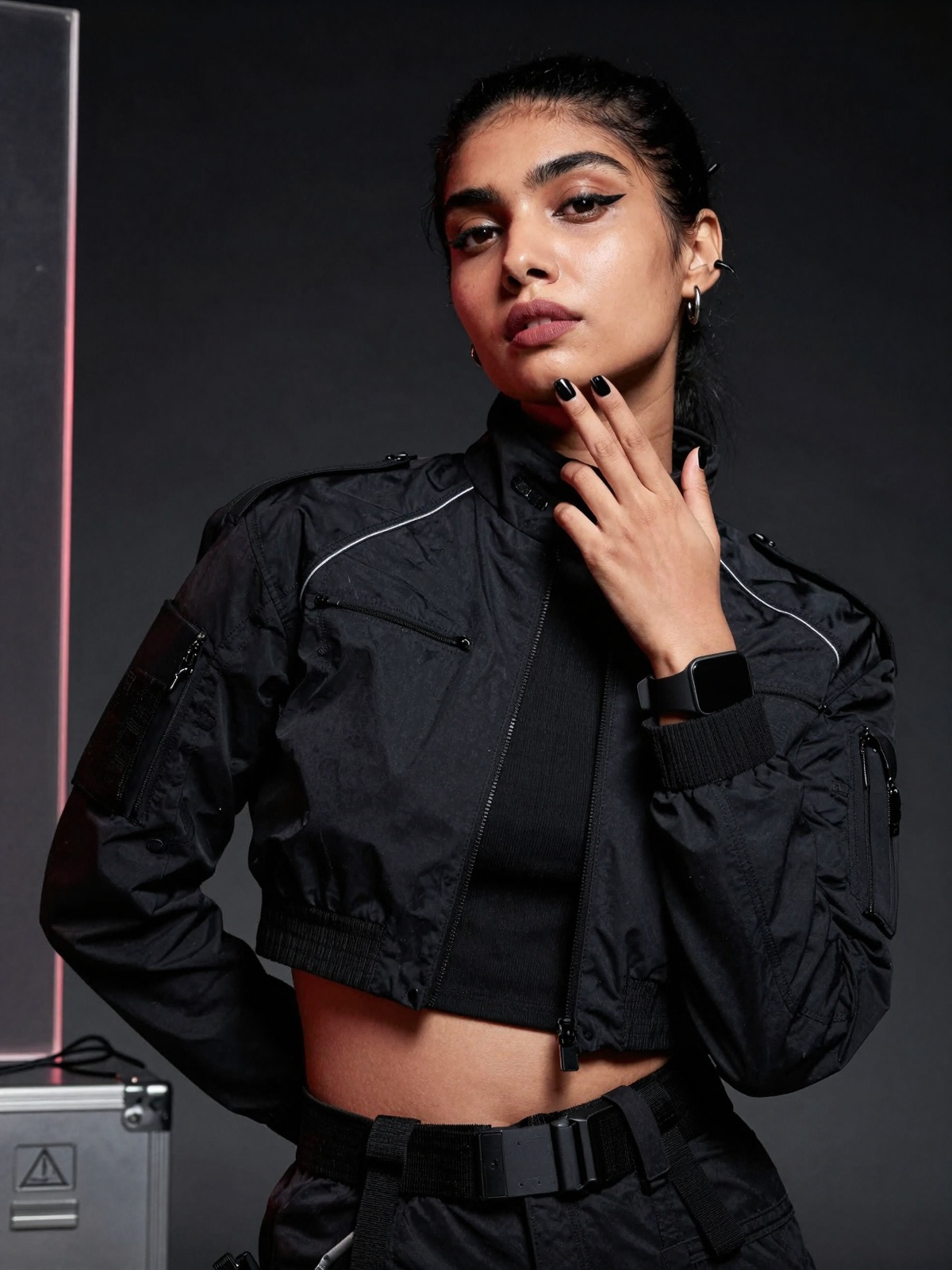 Close-up high-fashion editorial photoshoot portrait of a stunning south Asian woman in a cyberpunk-minimal tactical aesthe...