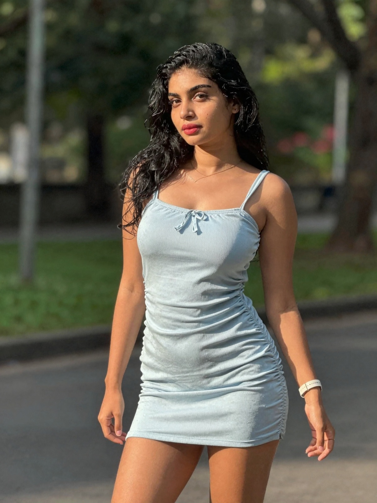 gorgeous woman in her 30s in a cute mini summer dress posing for a sensual photography session at a local park,  Mobile ph...