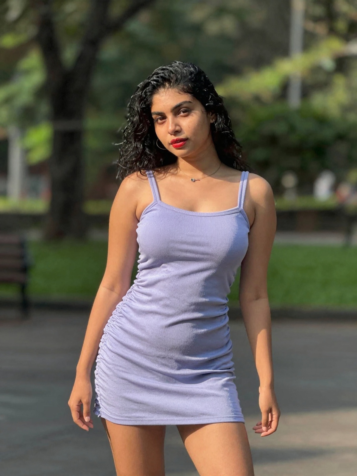 gorgeous woman in her 30s in a cute mini summer dress posing for a sensual photography session at a local park,  Mobile ph...