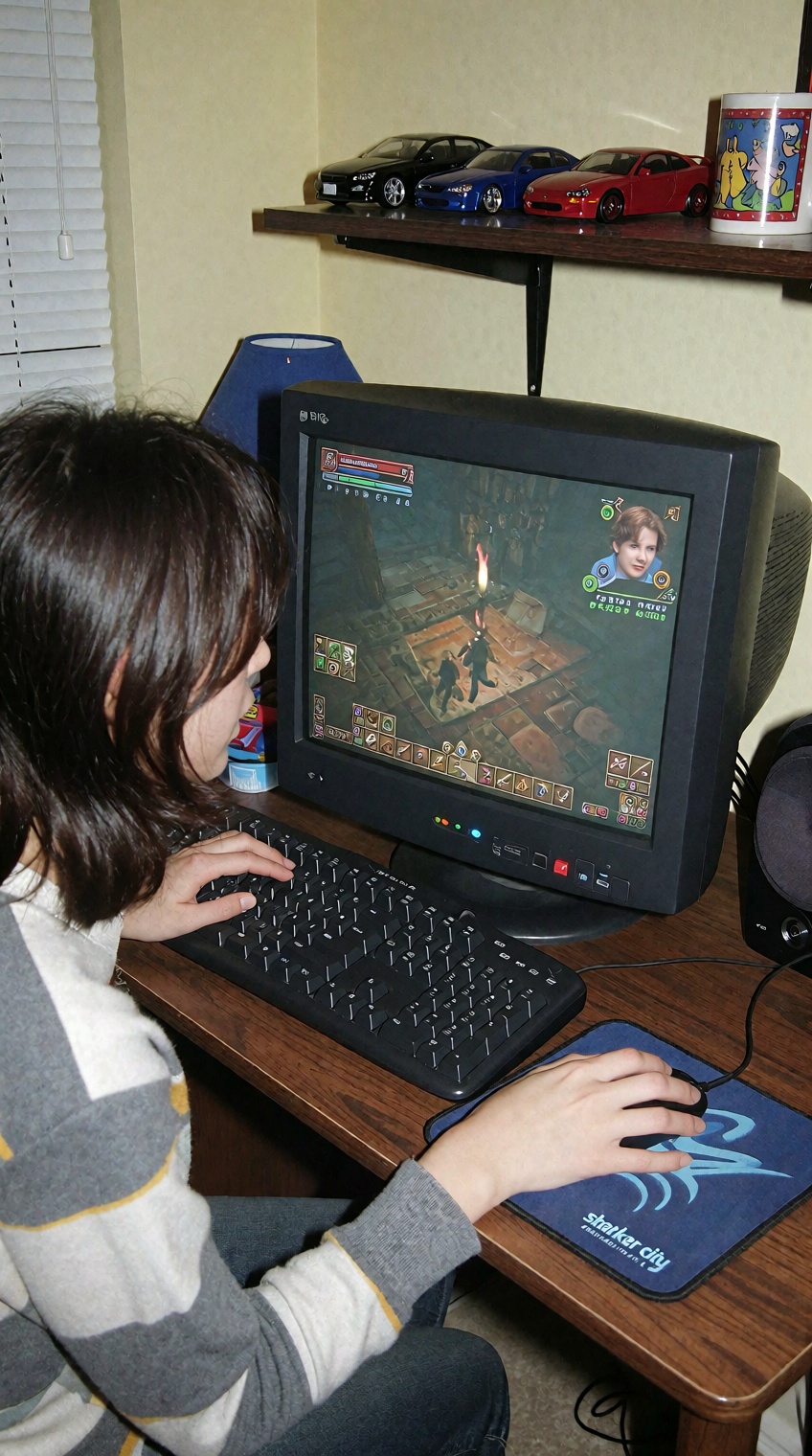 a person with shoulder-length dark hair sits at a wooden desk,  facing a crt monitor displaying a fantasy-themed video gam...