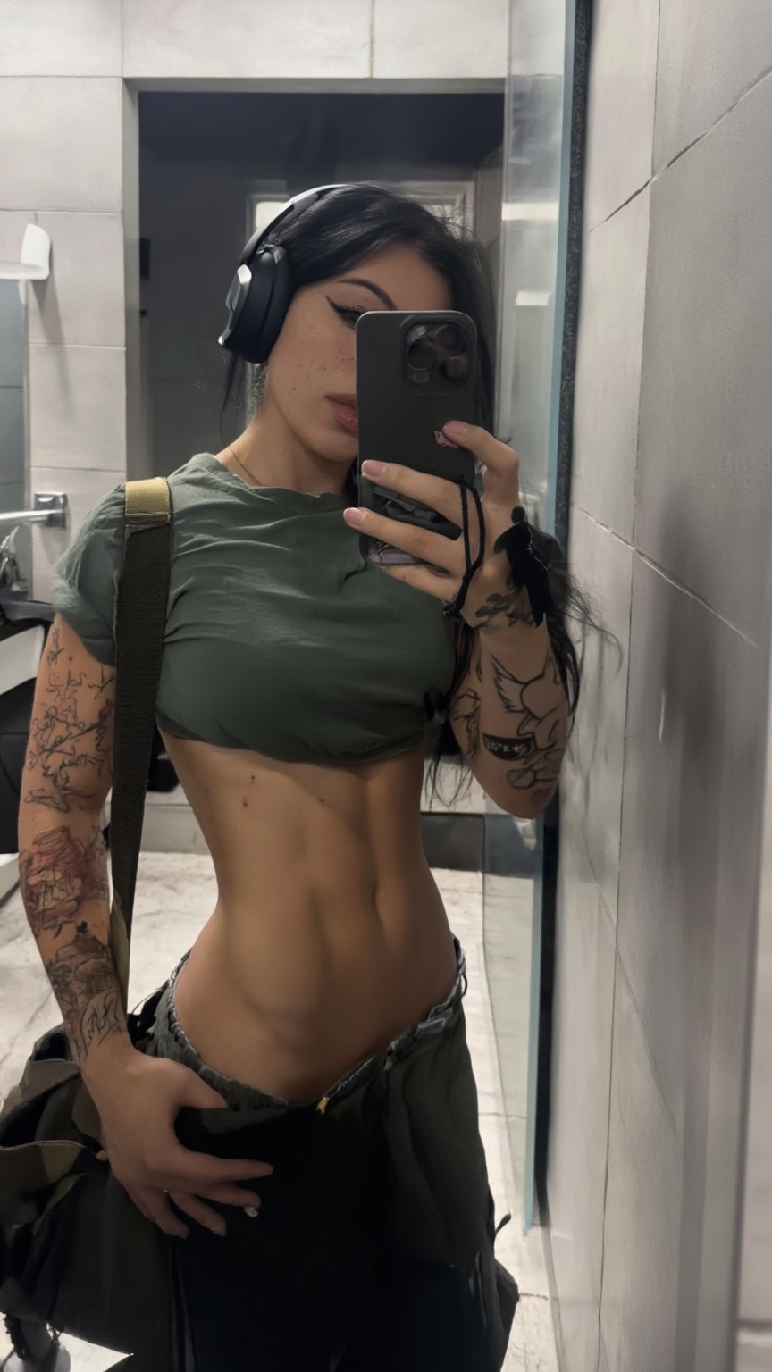 Highly detailed hyper-realistic mirror selfie of a fit young woman with dark hair,  large headphones,  and extensive arm t...