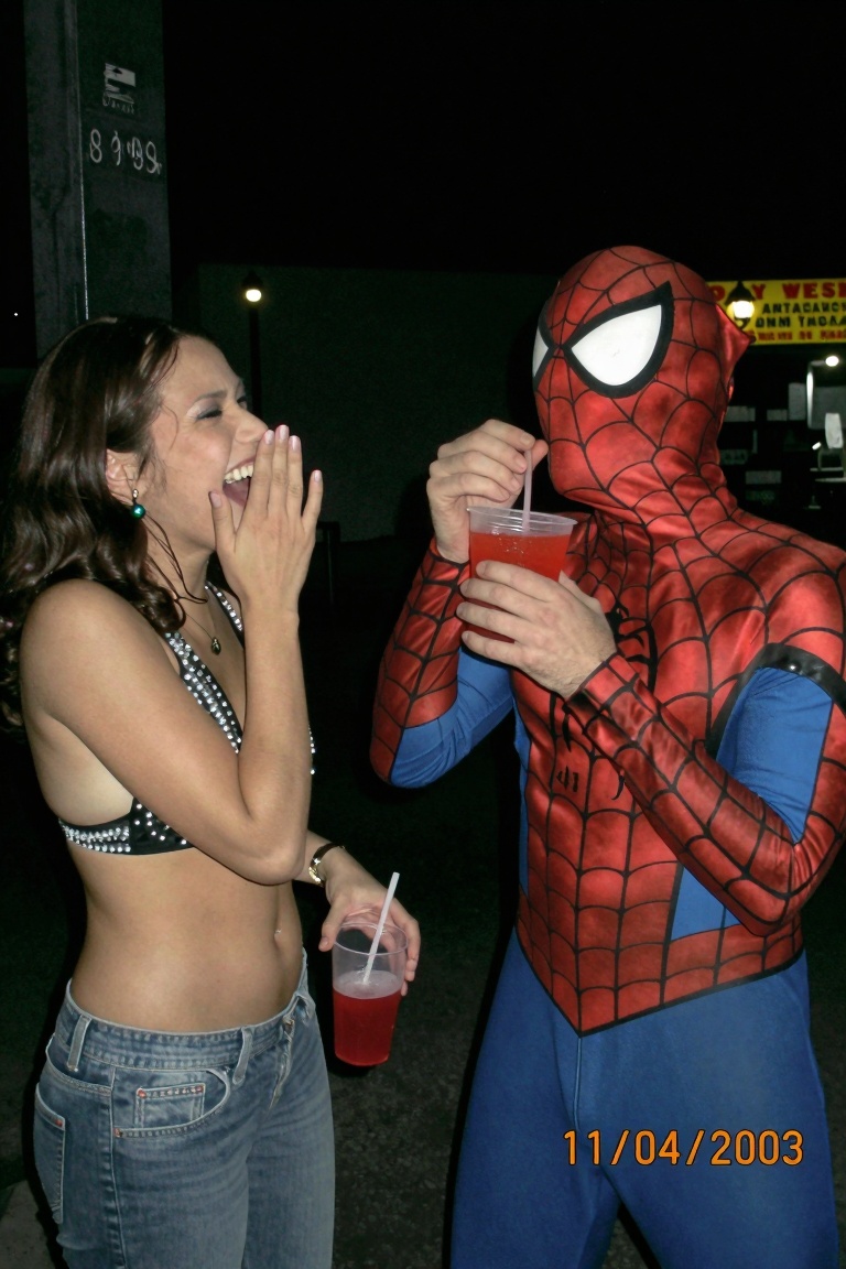 A funny,  candid 2000s digicam photo capturing a hilarious scene at a dimly lit outdoor street food stall at night. A beau...