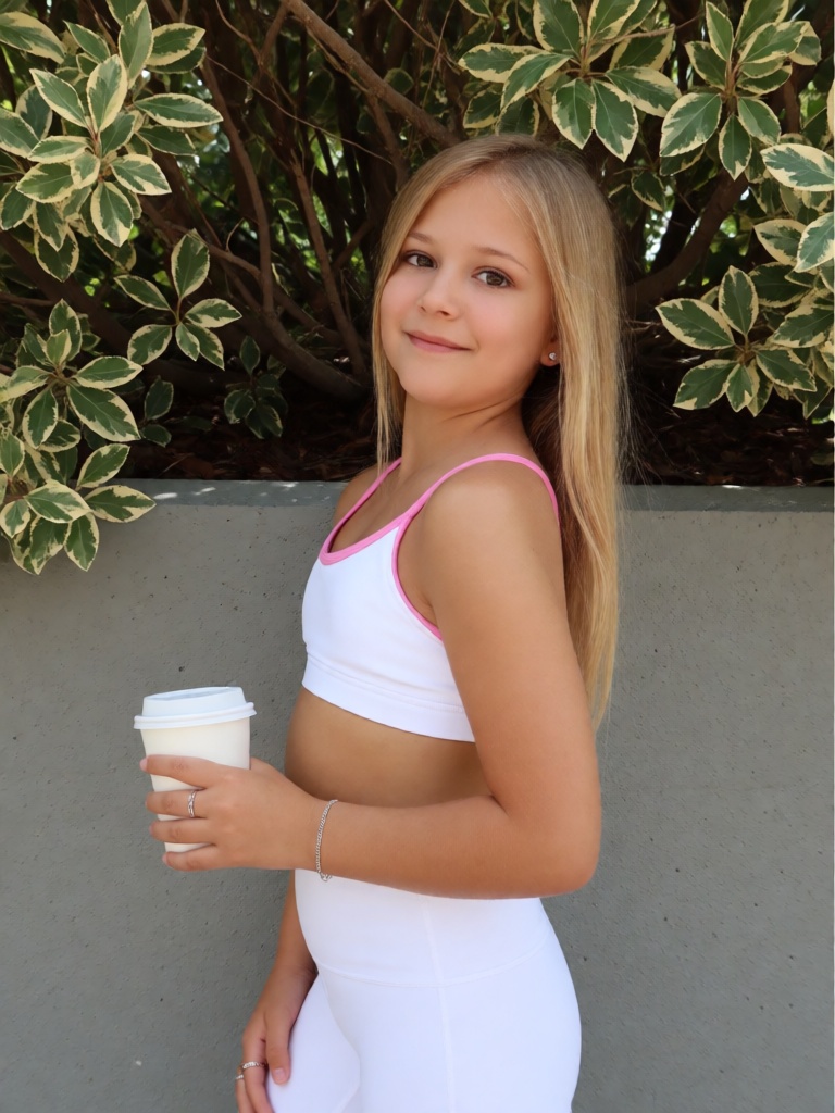 ******* point-and-shoot photo of a young woman rlyhelga with blonde hair ,  A young woman with long,  straight blonde hair...