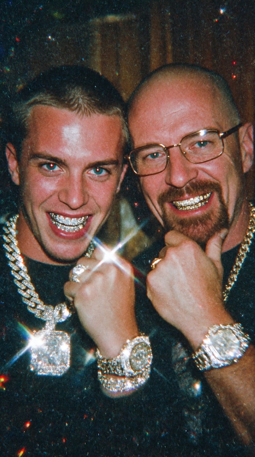 A raw,  candid party photograph from the mid-2000s captured with a harsh direct camera flash. The photo shows two men rese...