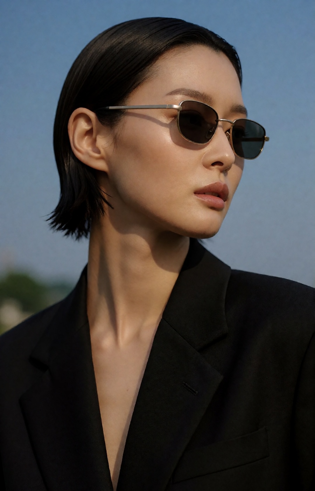 high-fashion beauty editorial,  close-up portrait of a young korean woman with a sleek wet-look short bob,  minimalist gol...