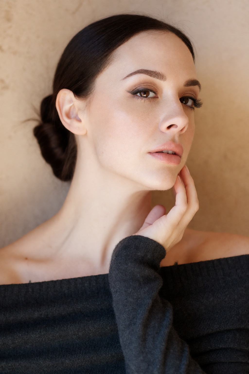 A deeply aesthetic,  close-up head and shoulders portrait of woCh40n with dark hair styled in a sleek,  low bun on Tensor.Art