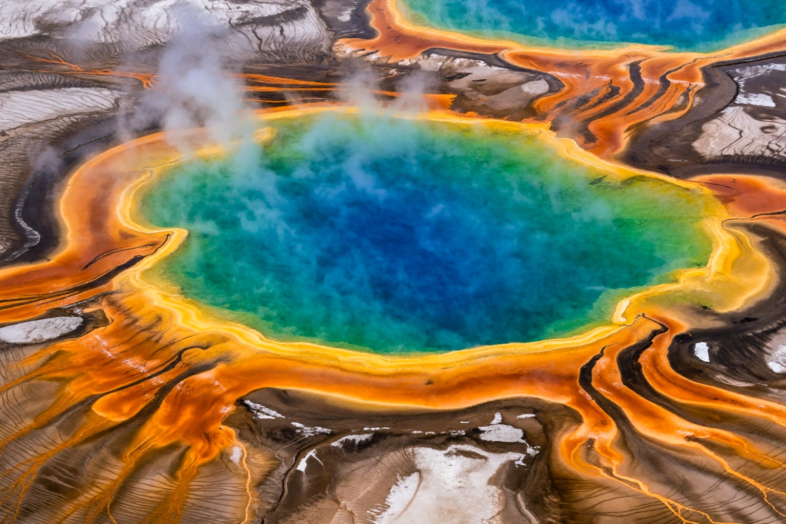 aurelmanea7k2e6 photography. An astonishing aerial or slightly elevated wide-angle view of the Grand Prismatic Spring in Y...