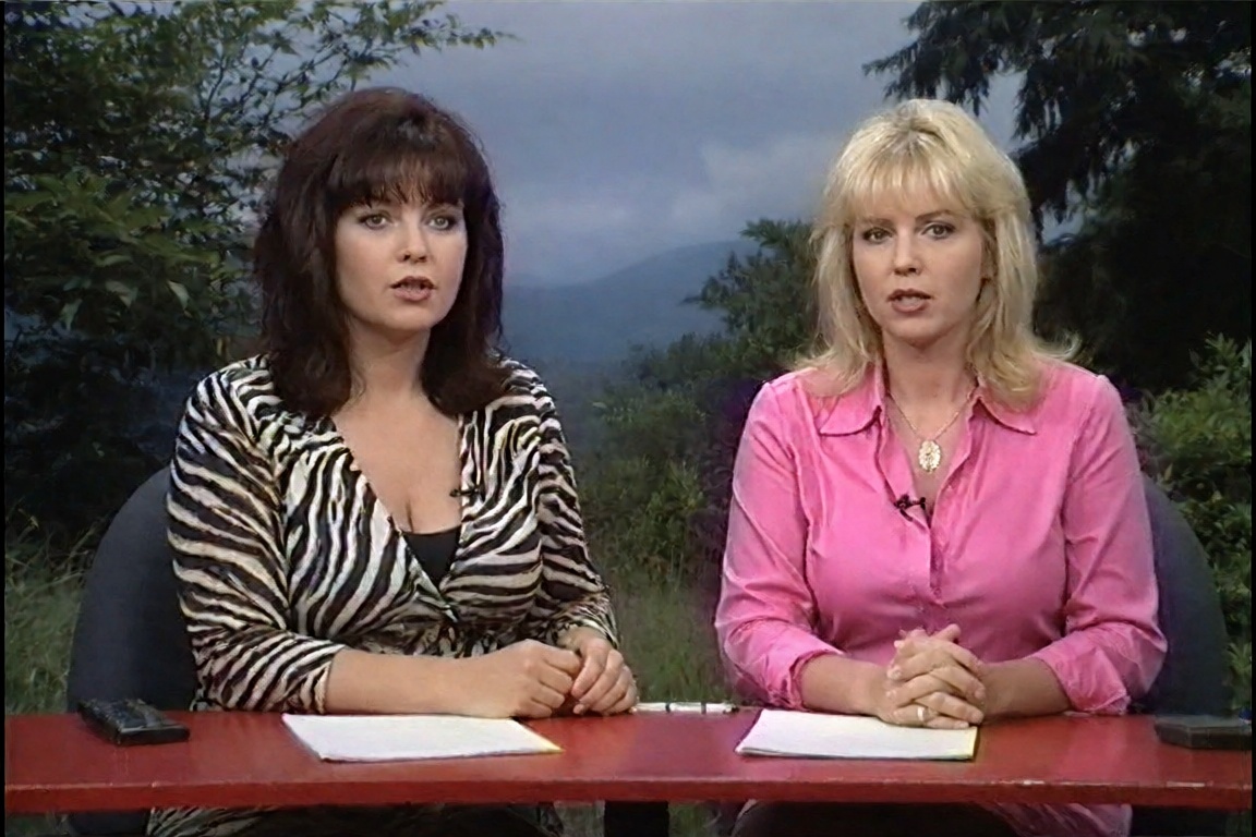 two women,  one in a zebra-print top and one in a bright pink shirt,  host a talk show at a red table on Tensor.Art