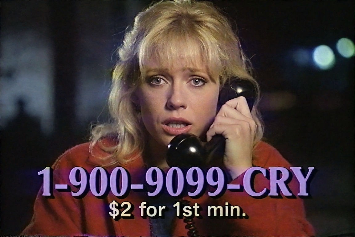 a distressed blonde woman in a red jacket holds a telephone in a late-night commercial promoting "1-900-9099-CRY" for "$2...
