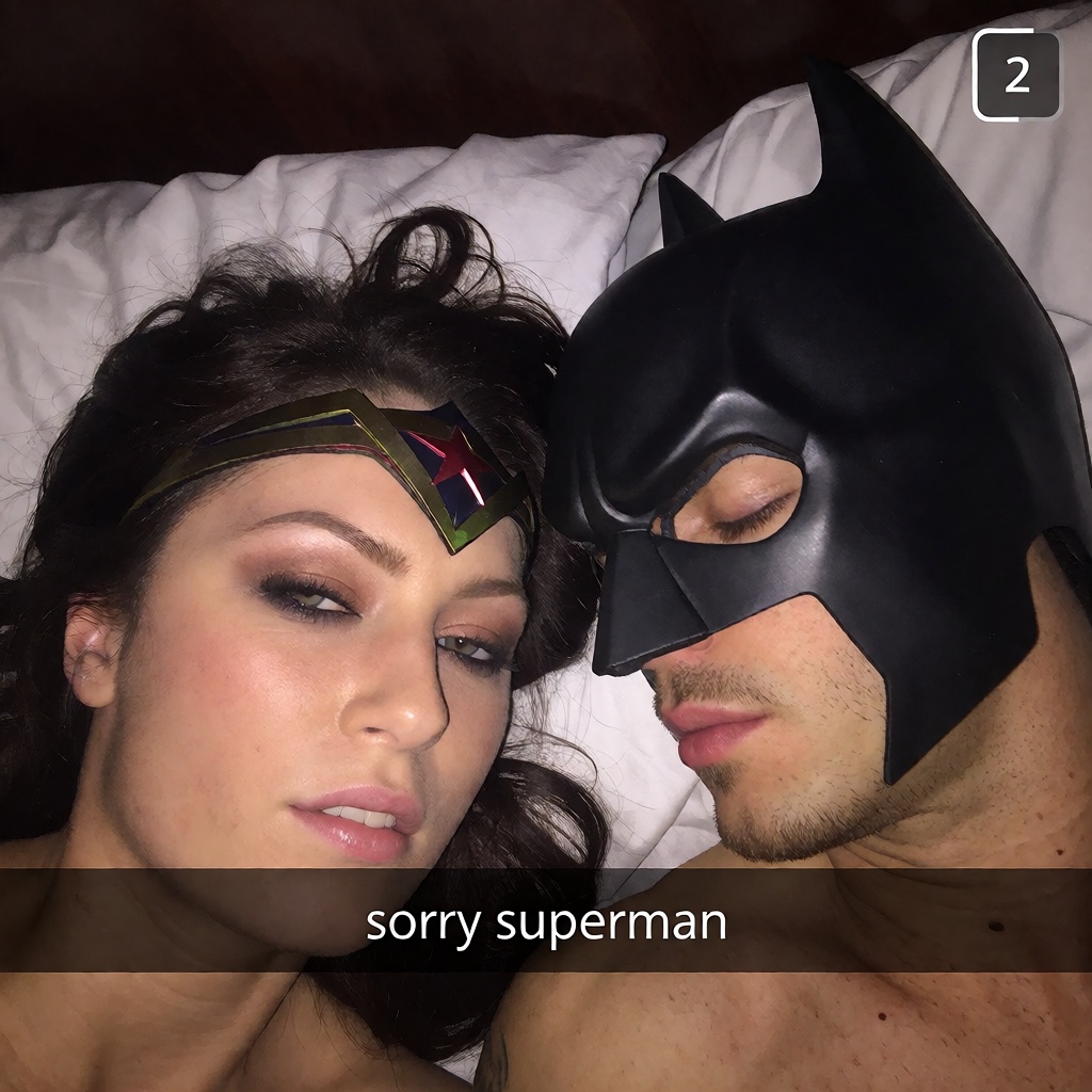 A candid ******* selfie shot on iphone 6 by wonder woman in her bed next to a sleeping batman with his mask on ,  captions...