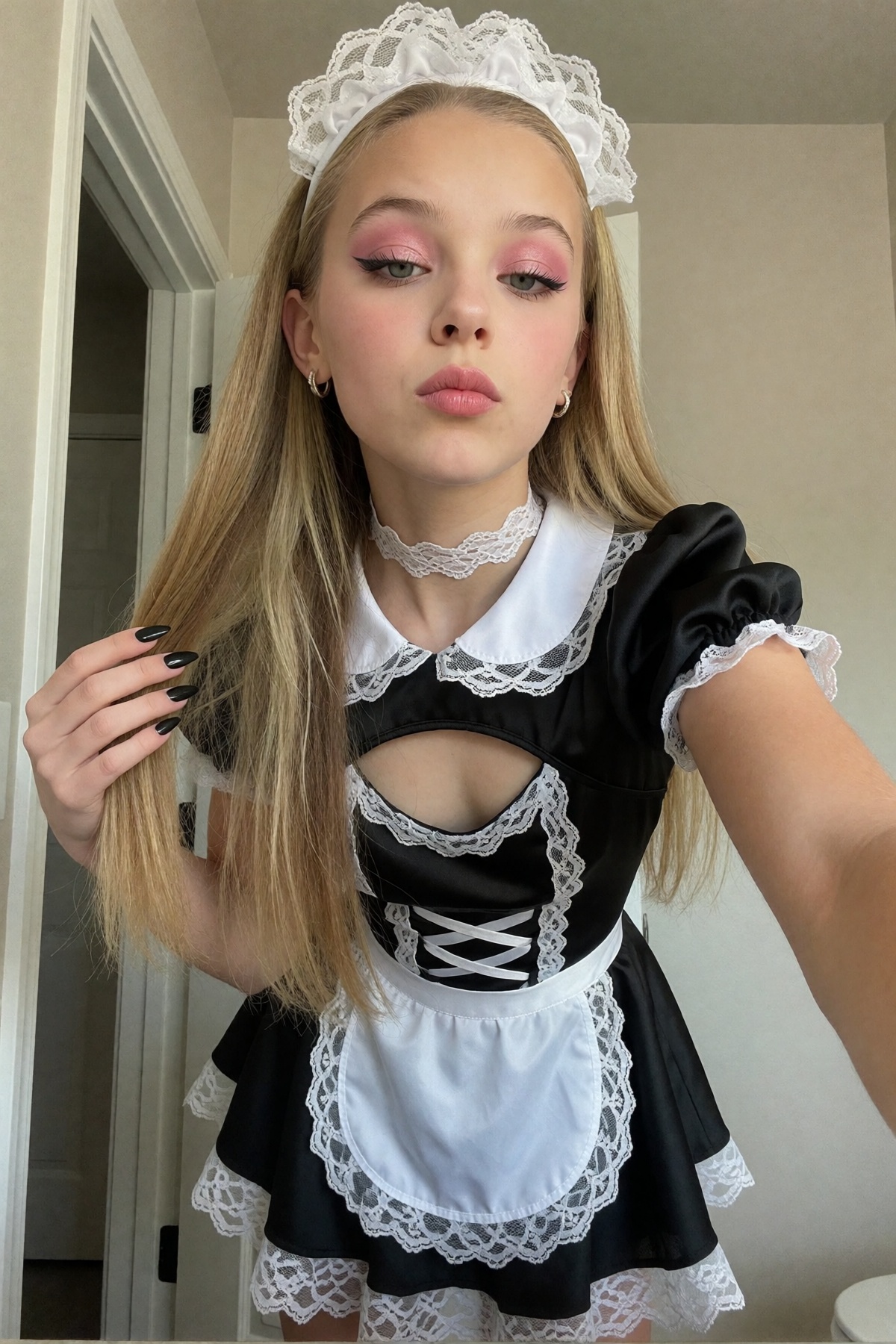 A young girl in her early twenties with long,  straight hair,  centered in a close face portrait selfie taken from sightly...