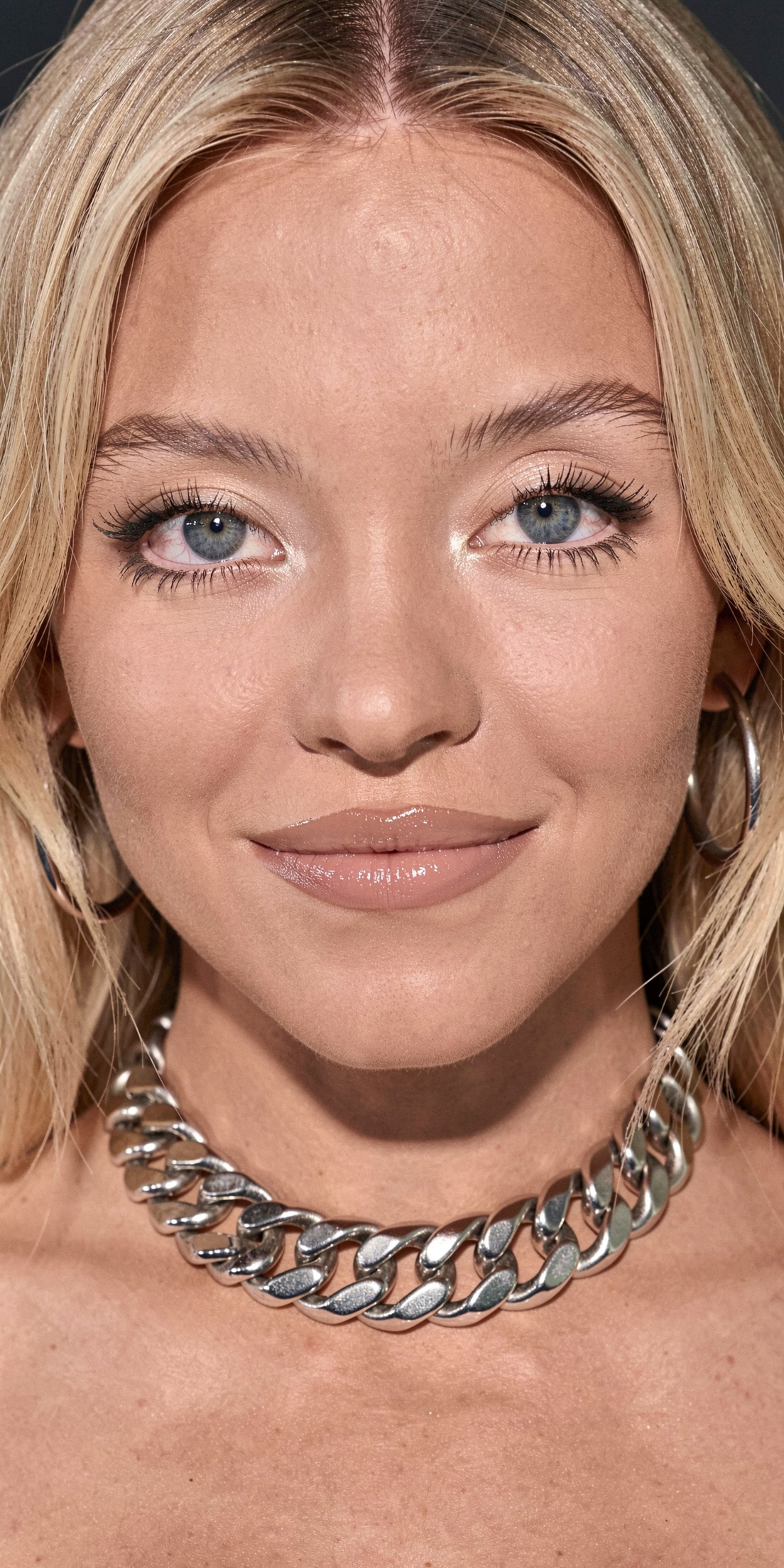 an ultra-close-up professional DSLR photograph of an exceptionally attractive young Caucasian woman named Sydney Sweeney....