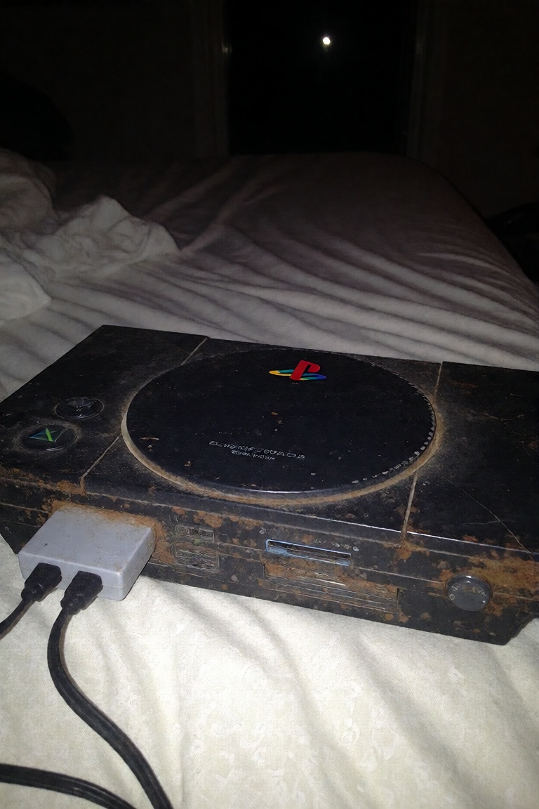 ******* old leaked photo shot on iphone 4 of a playstation 2 on a bed all rusty,  lkd,  old leaked photo on Tensor.Art