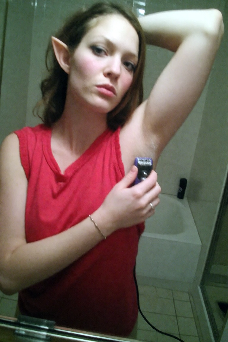 A candid ******* old leaked photo of a beautiful elf wearing a red sleeveless shirt standing on her bathroom caught shavin...