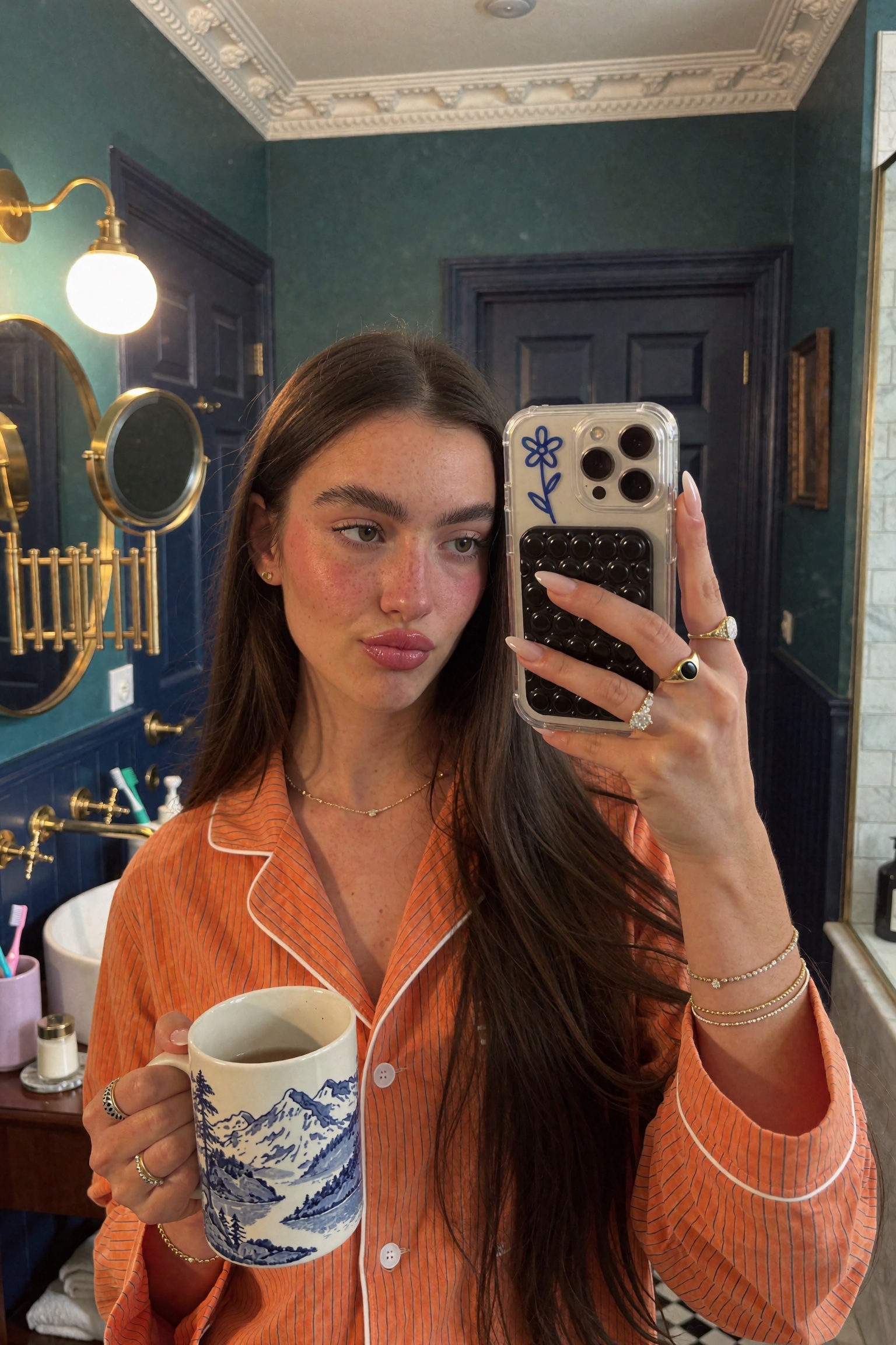 Unedited iPhone snapshot (mirror selfie,  close-up upper-body framing) of a young woman in her early twenties,  with warm...