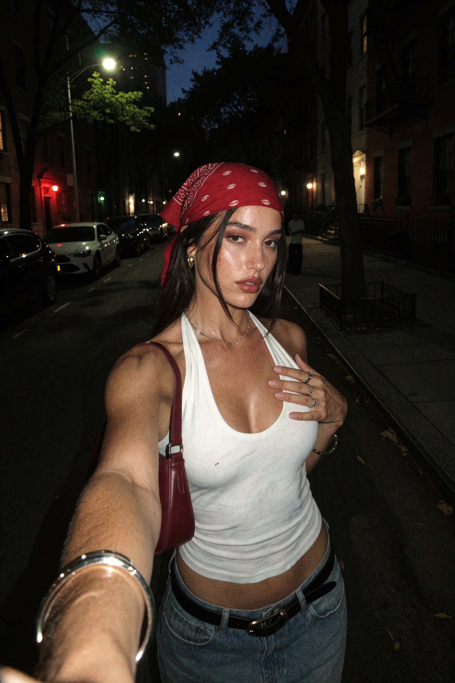 Candid nighttime smartphone selfie of an ***** woman walking on a city street,  close wide-angle arm’s-length framing with...