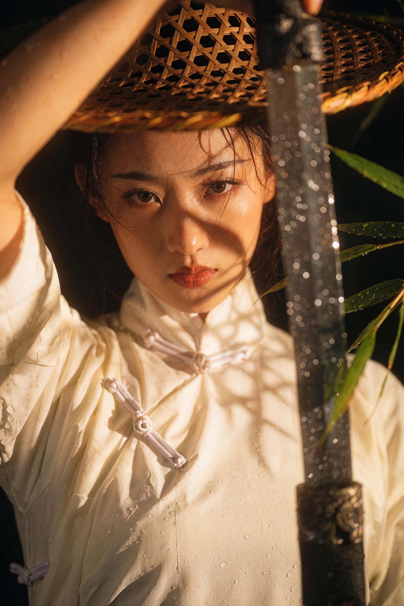 Cinematic wuxia film-still close-up portrait of a young swordswoman with an intense direct gaze into the lens,  one arm ra...