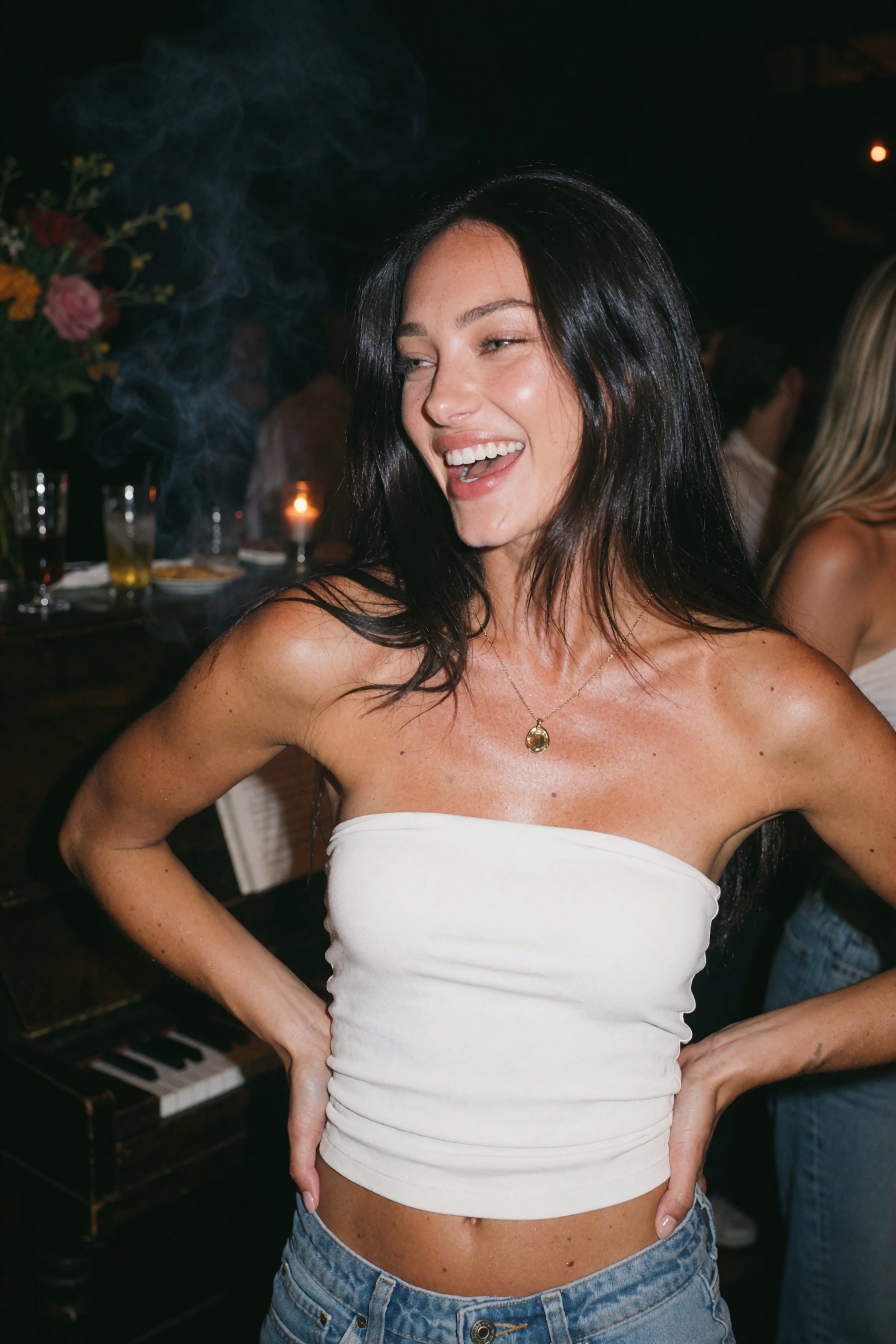 Direct-flash point-and-shoot photograph of an ***** woman at a crowded afterparty,  framed waist-up,  body angled slightly...