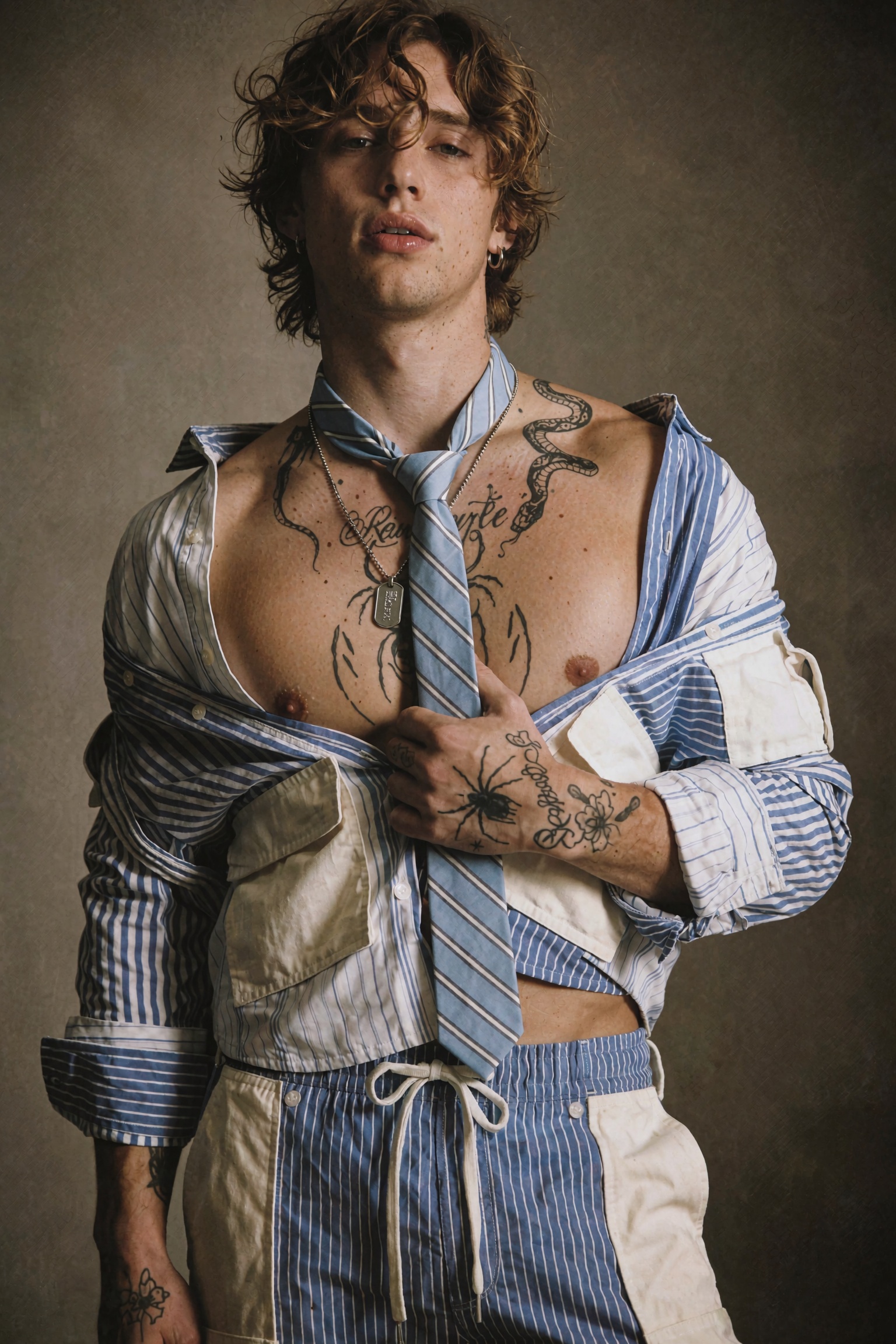 Cinematic high-fashion editorial photograph of a young man in a waist-up studio portrait,  head tilted slightly back with...