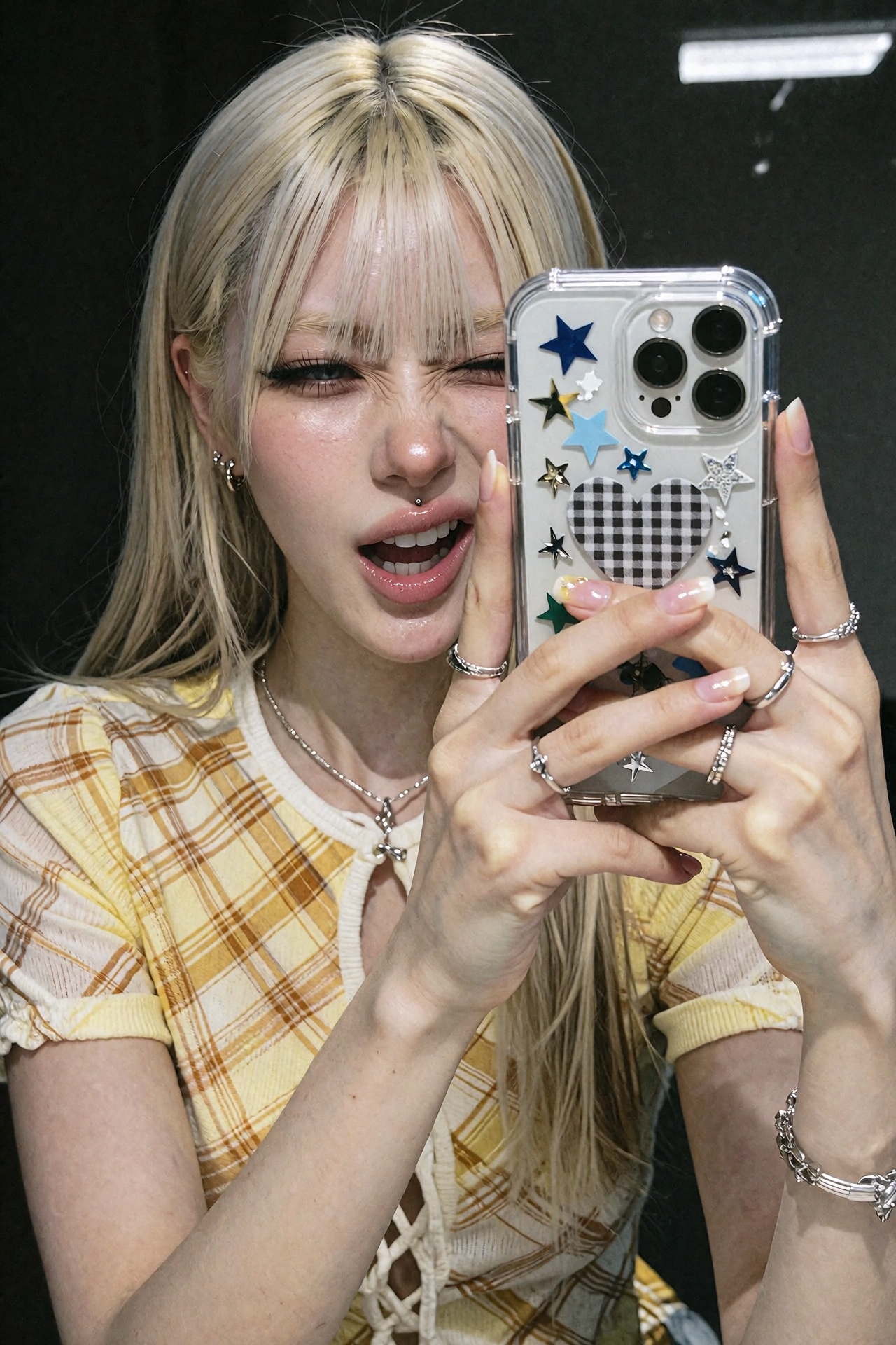 Cinematic editorial close-up mirror-selfie portrait photograph of a young woman with straight platinum blonde hair with bl...