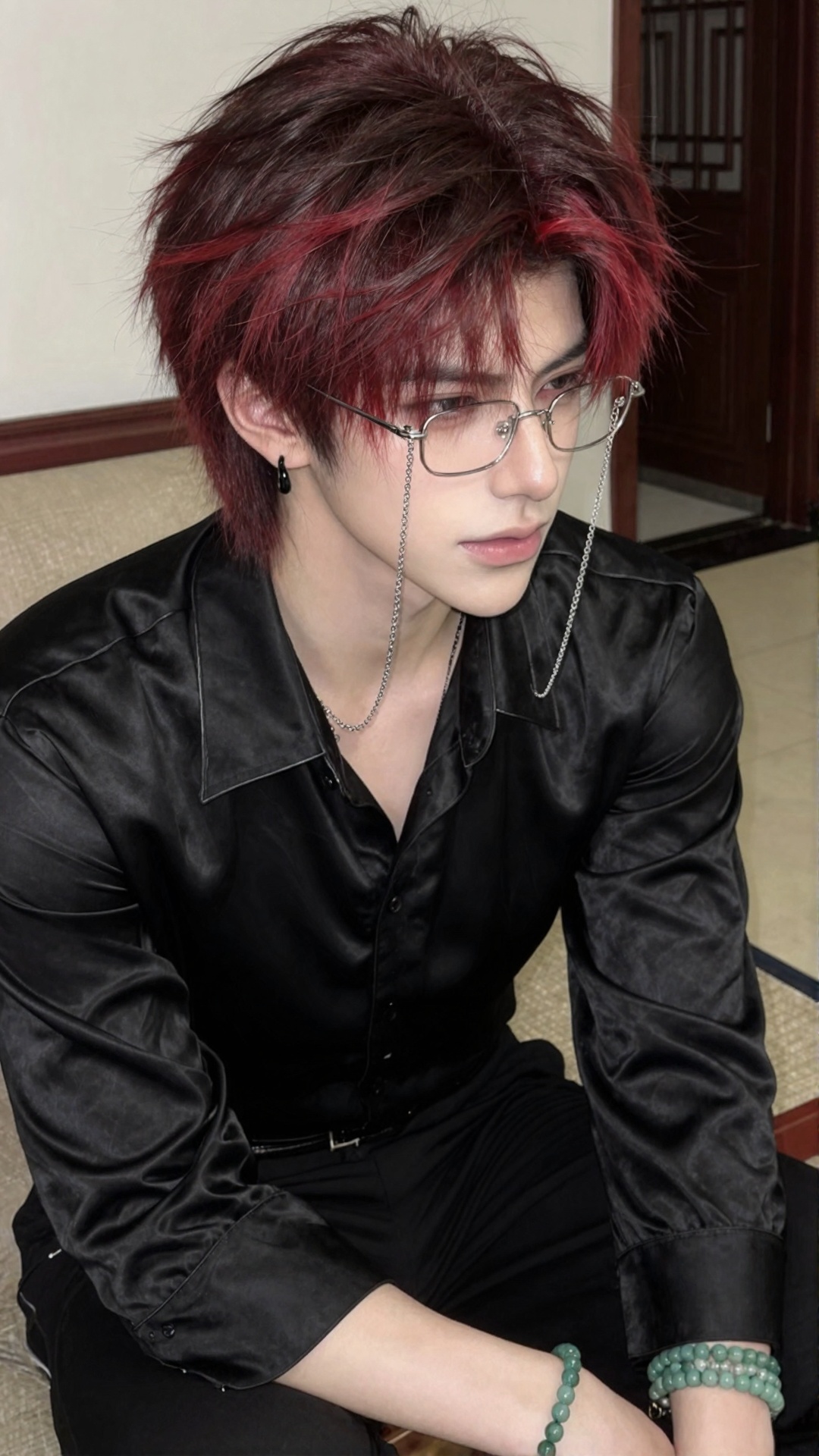 A young man (solo shot) with short,  tousled hair—dark brown blending into red,  with some red strands; fair skin; slicked...