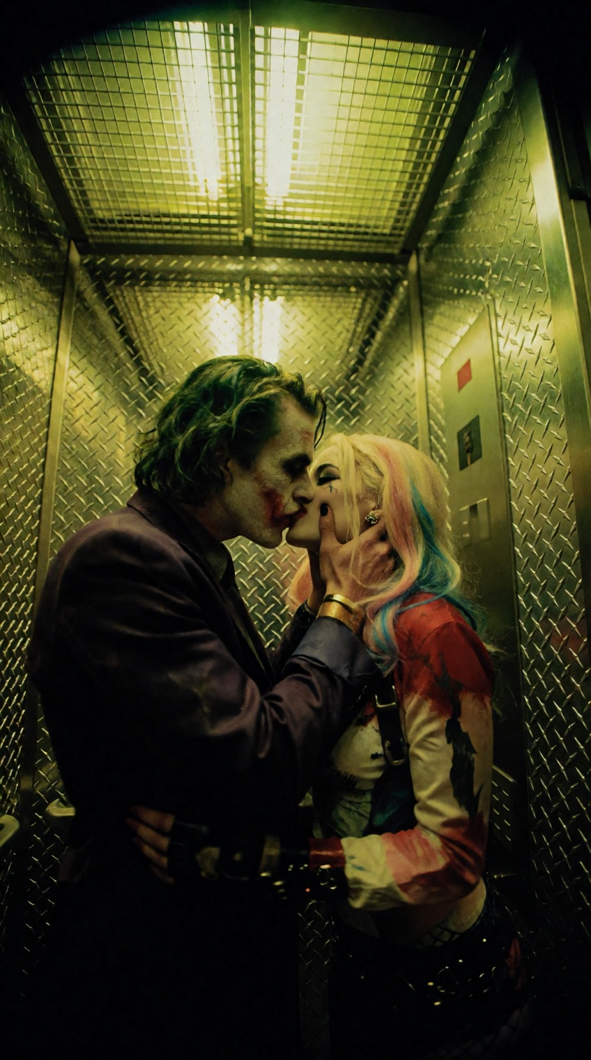 @oswaldo_cepeda,  The Joker and Harley Quinn share a chaotic,  passionate kiss inside a cramped industrial freight elevato...