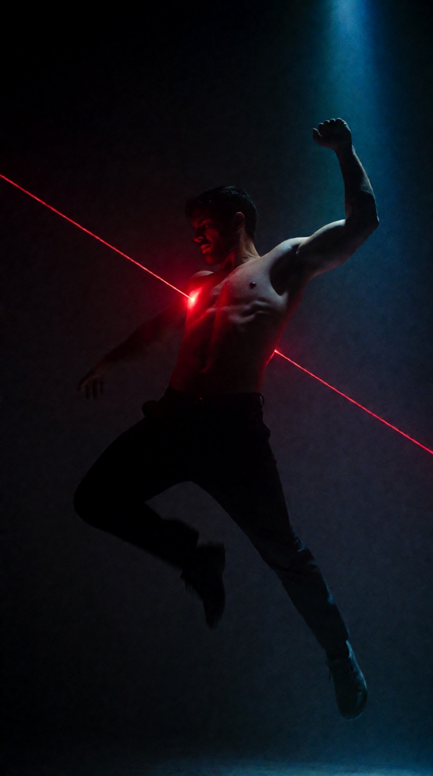 @oswaldo_cepeda,  a shirtless man is captured mid-leap against a near-black backdrop,  his body suspended in a dynamic on...