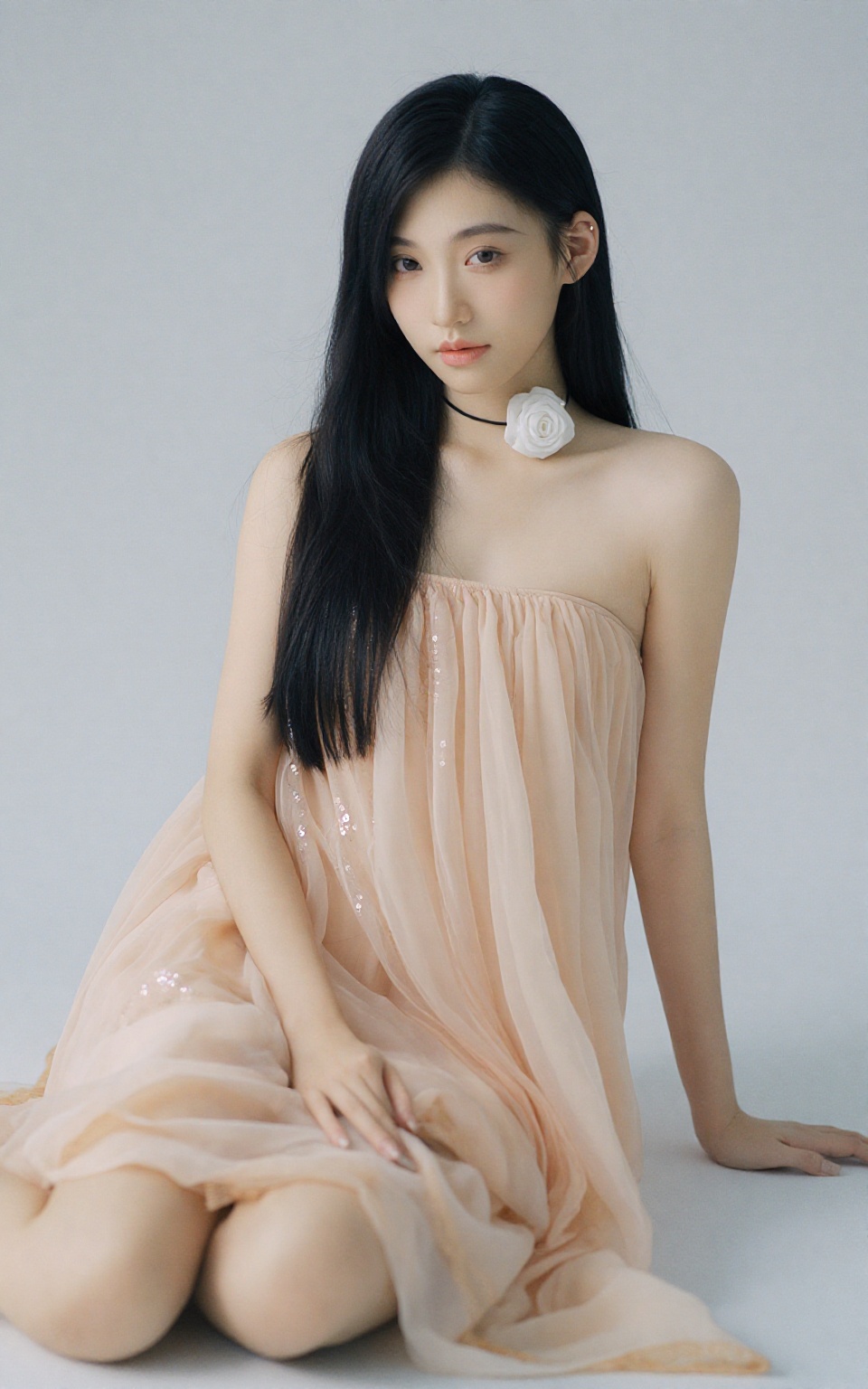 The image is a photograph of an East Asian woman with long,  straight,  black hair that cascades over her shoulders and do...