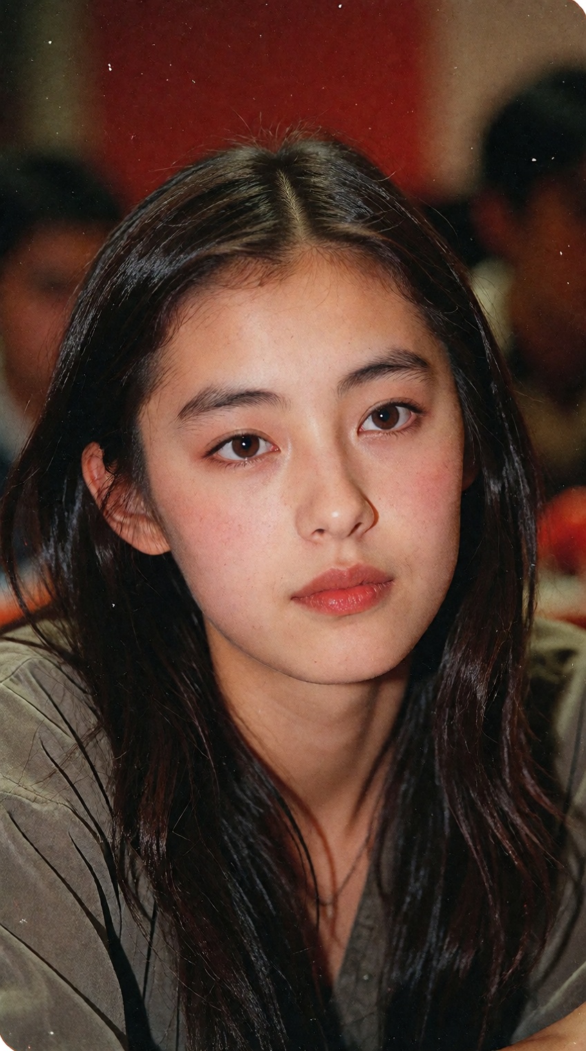A young woman with long,  straight black hair parted down the middle fills the frame,  her gaze directed slightly off to t...
